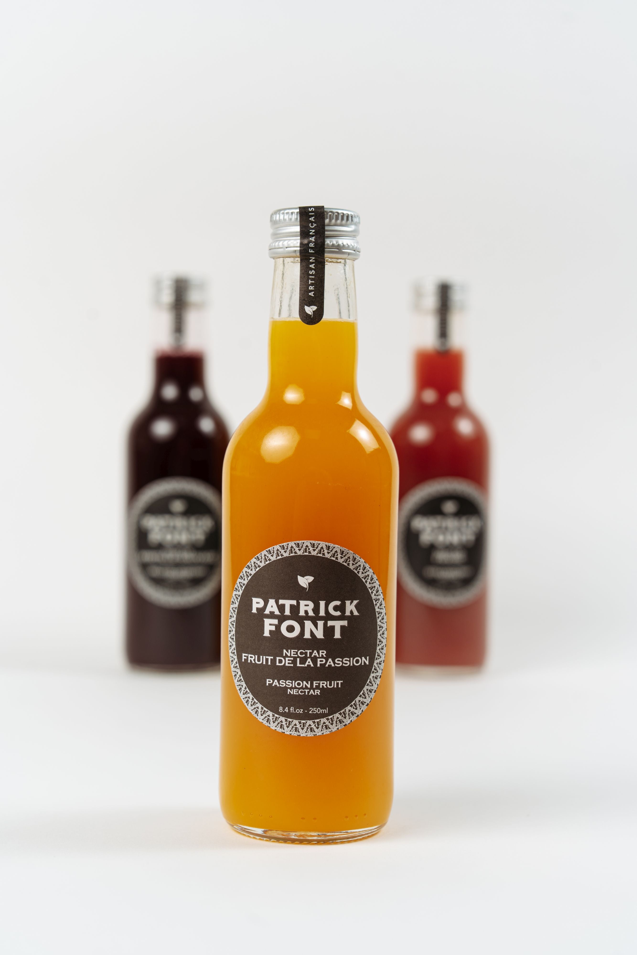 bottle of Patrick Font passion fruit nectar on white background