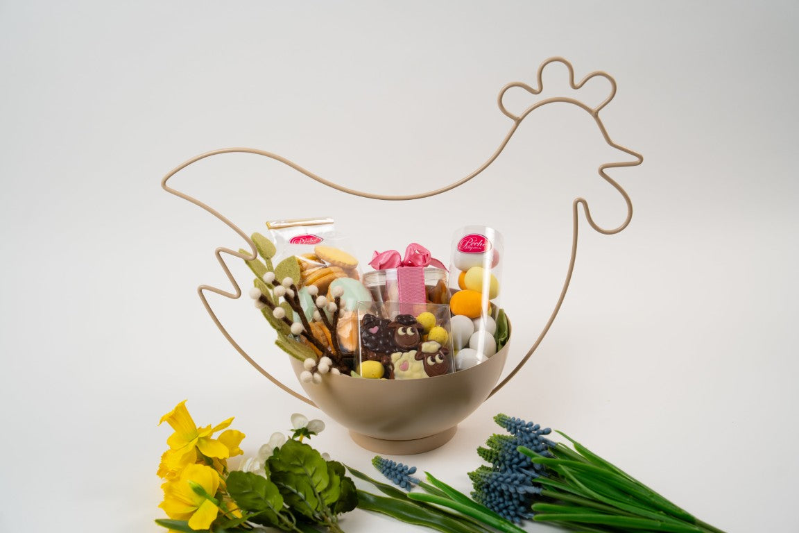 Easter gourmet assortment with chocolates, biscuits and decorated eggs presented in a decorative chicken stand from Le Péché Mignon.