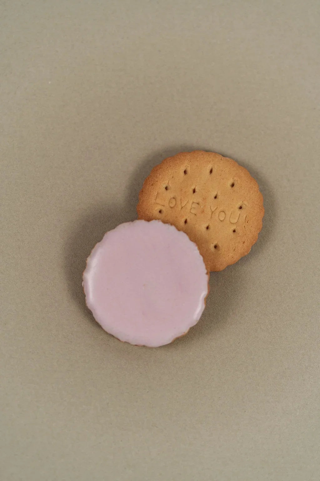 Pink iced sablé biscuit in detail