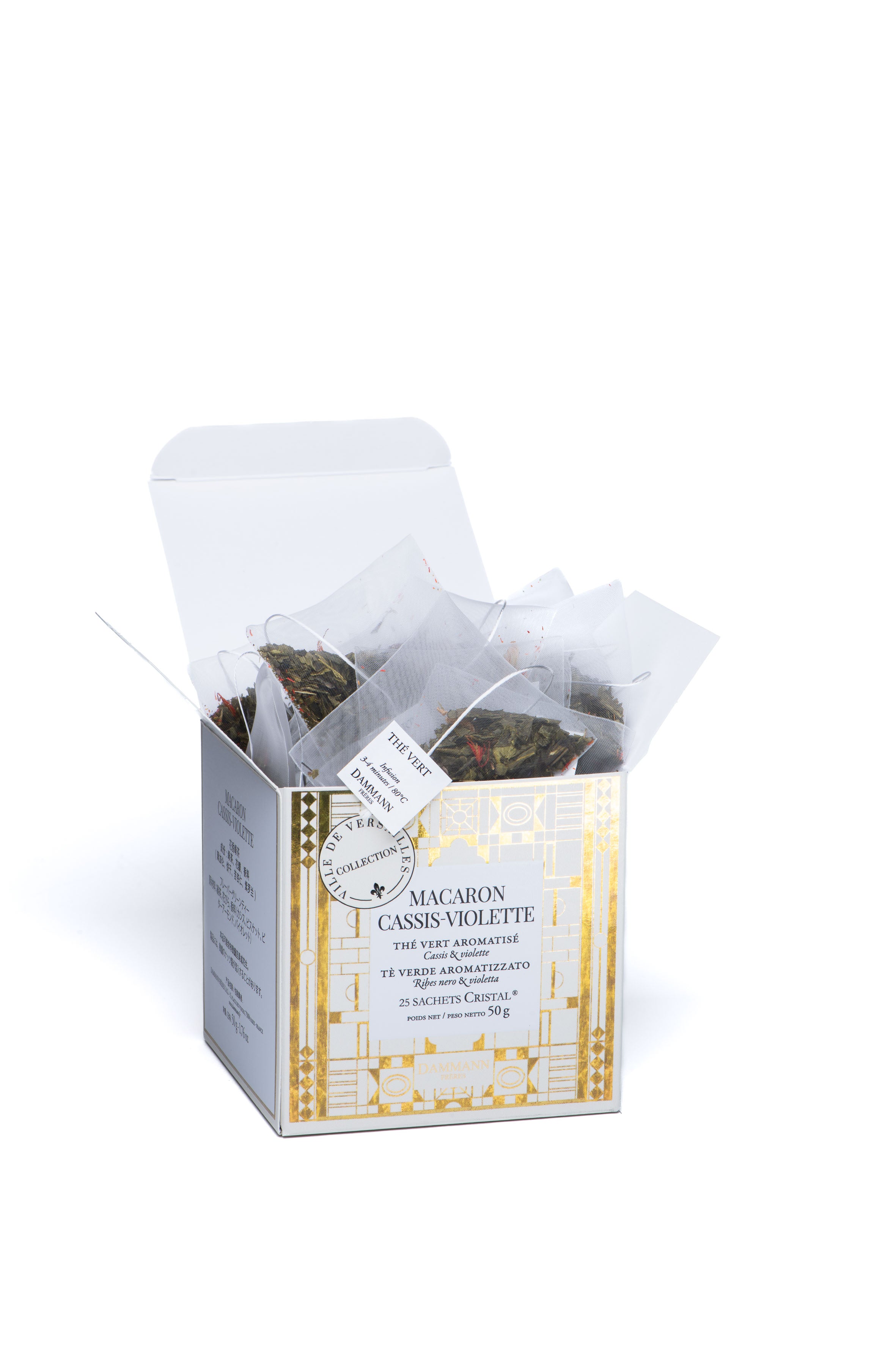 Boîte ouverte de thé vert Macaron Cassis-Violette Dammann Frères avec sachets présentés.