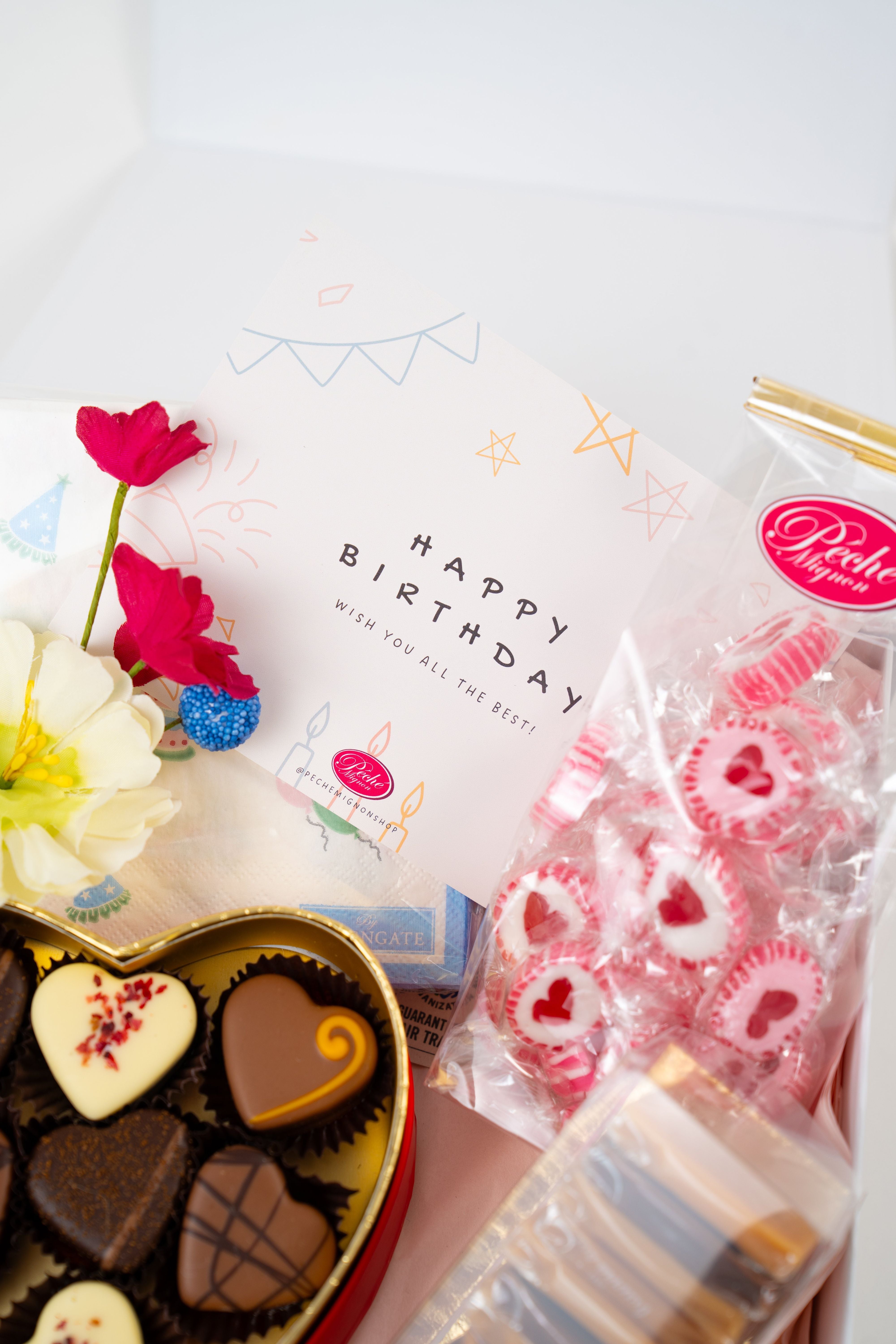 Luxury birthday gift box with artisan chocolate pralines, gourmet caramels and heart candies by Péché Mignon.
