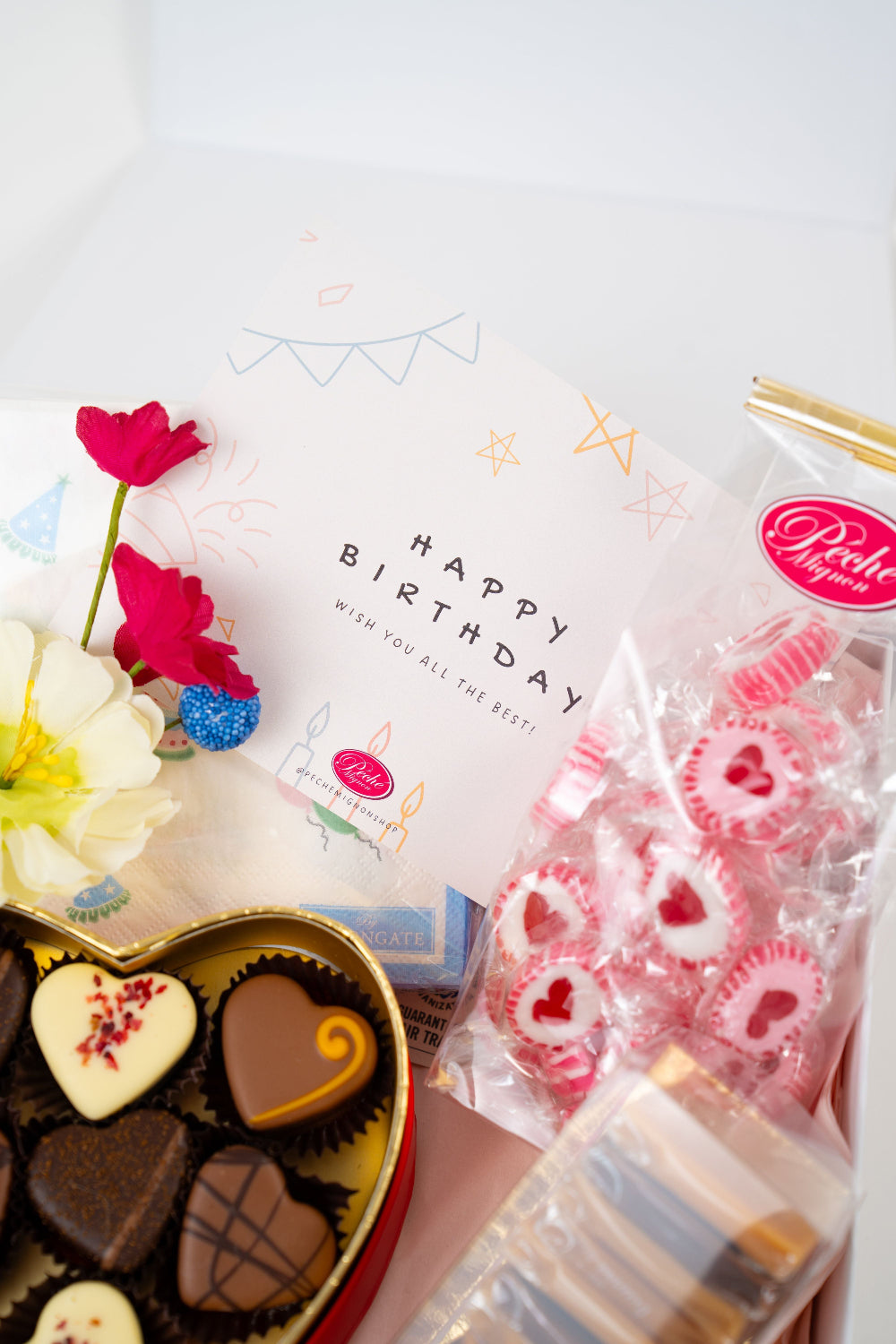 Luxury birthday gift box with artisan chocolate pralines, gourmet caramels and heart candies by Péché Mignon.