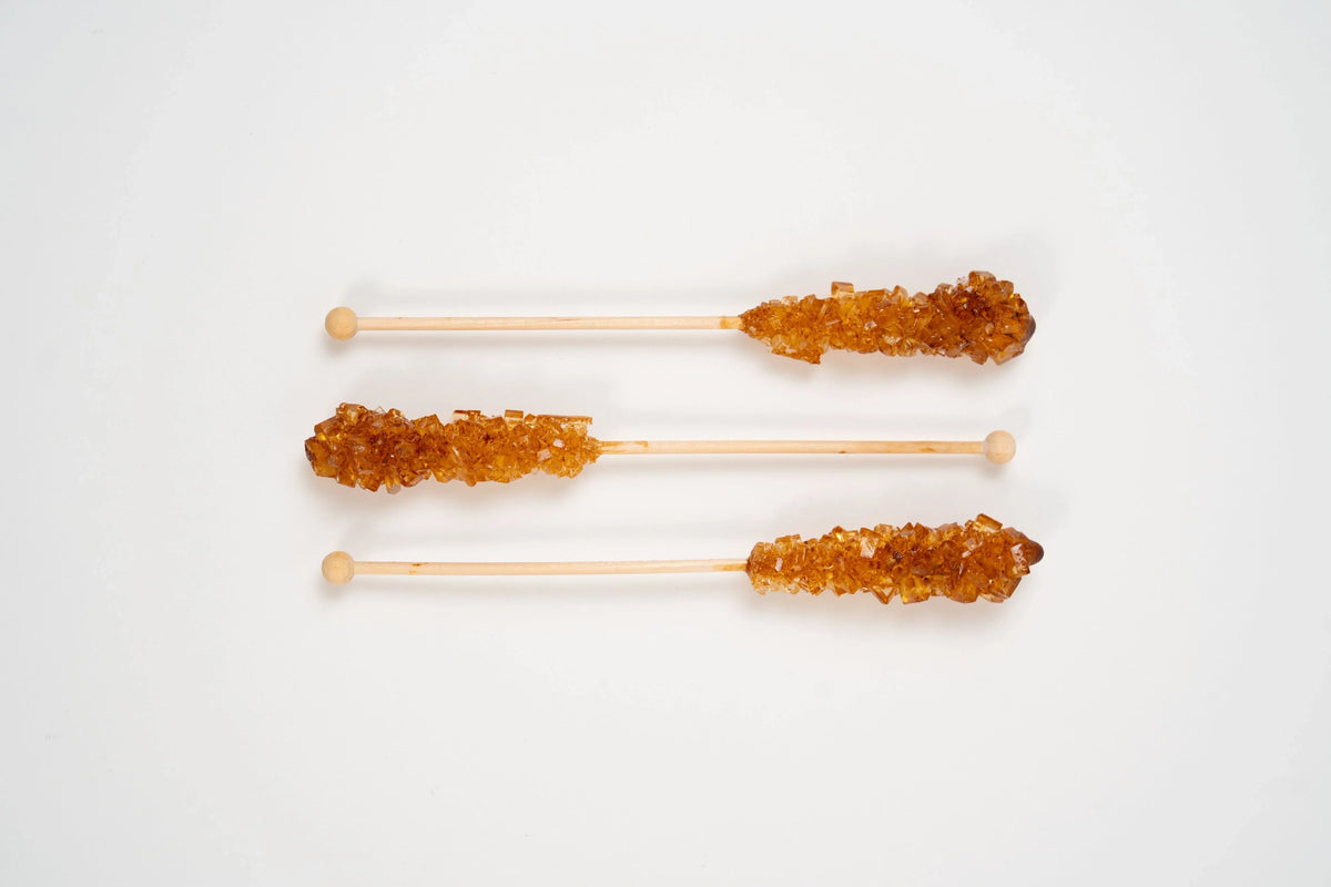 Brauner kandis brown rock sugar crystals on wooden sticks for tea sweetener