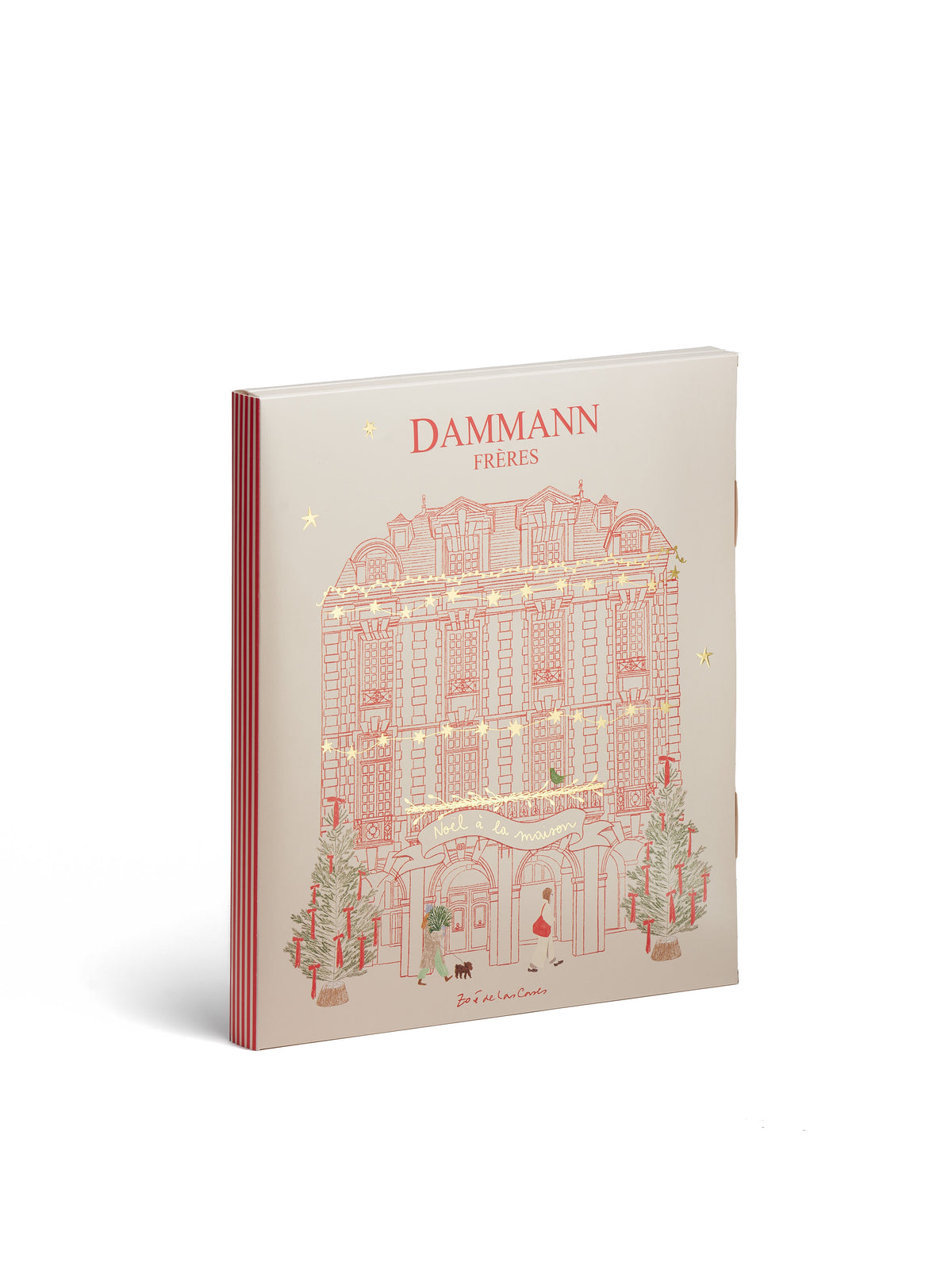 Calendrier de l’Avent Dammann Frères 2026 présenté fermé et ouvert, avec une façade parisienne illustrée sur la couverture et 24 cases décorées de scènes de Noël à l’intérieur.