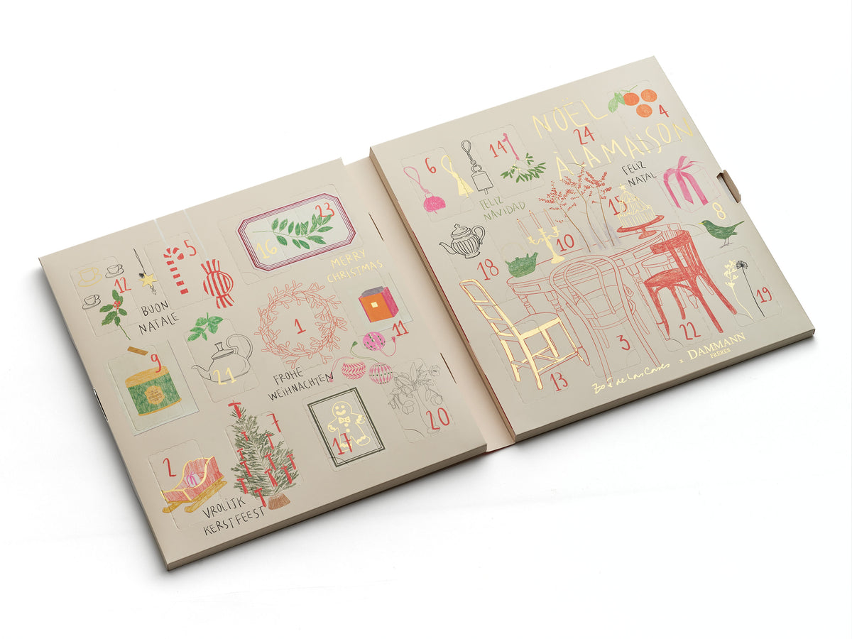 Calendrier de l’Avent Dammann Frères 2026 ouvert, dévoilant ses 24 cases numérotées et ses illustrations de Noël, dans des tons crème, rouge, vert et doré.