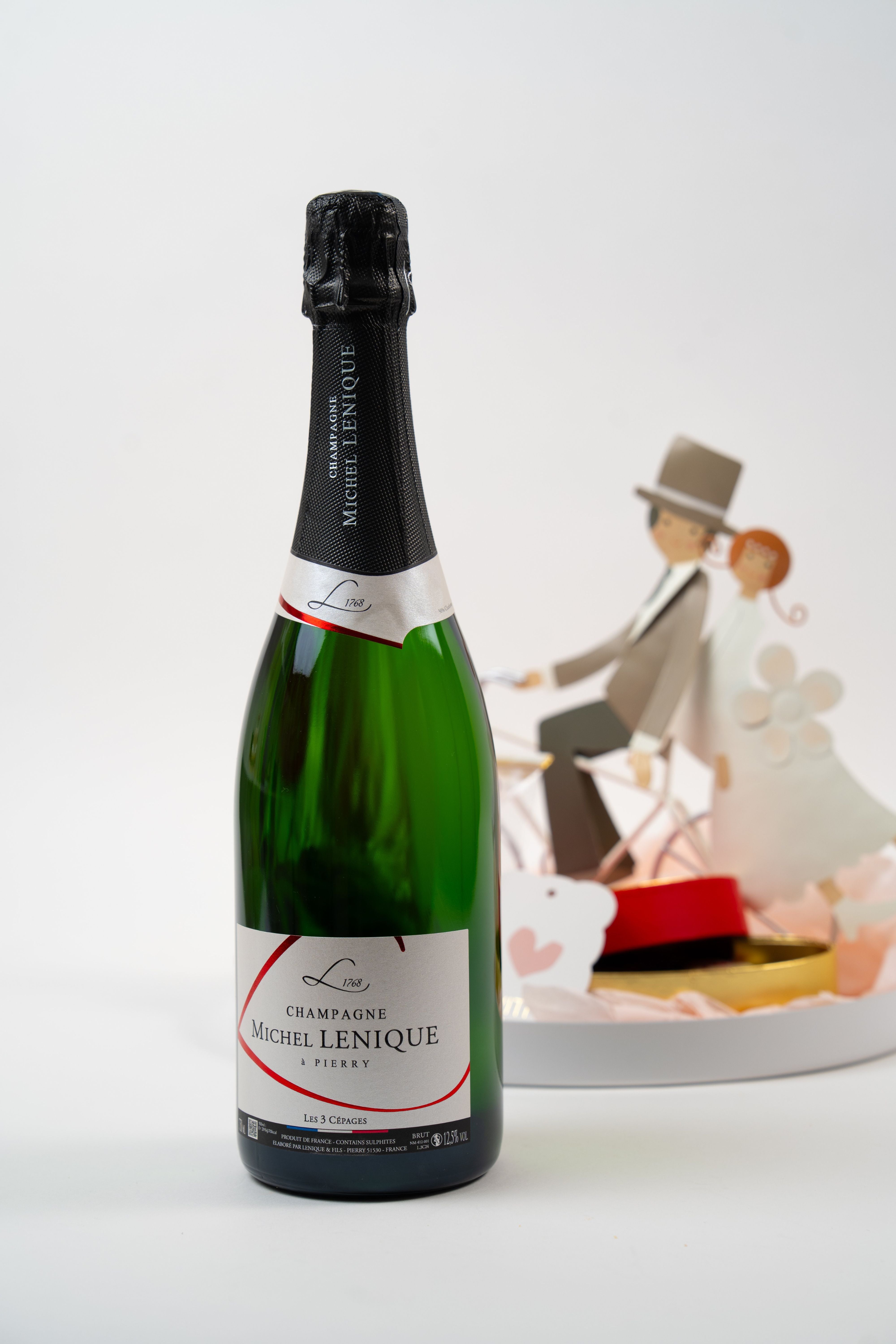 Champagne bottle with romantic chocolate gift tray from Péché Mignon.