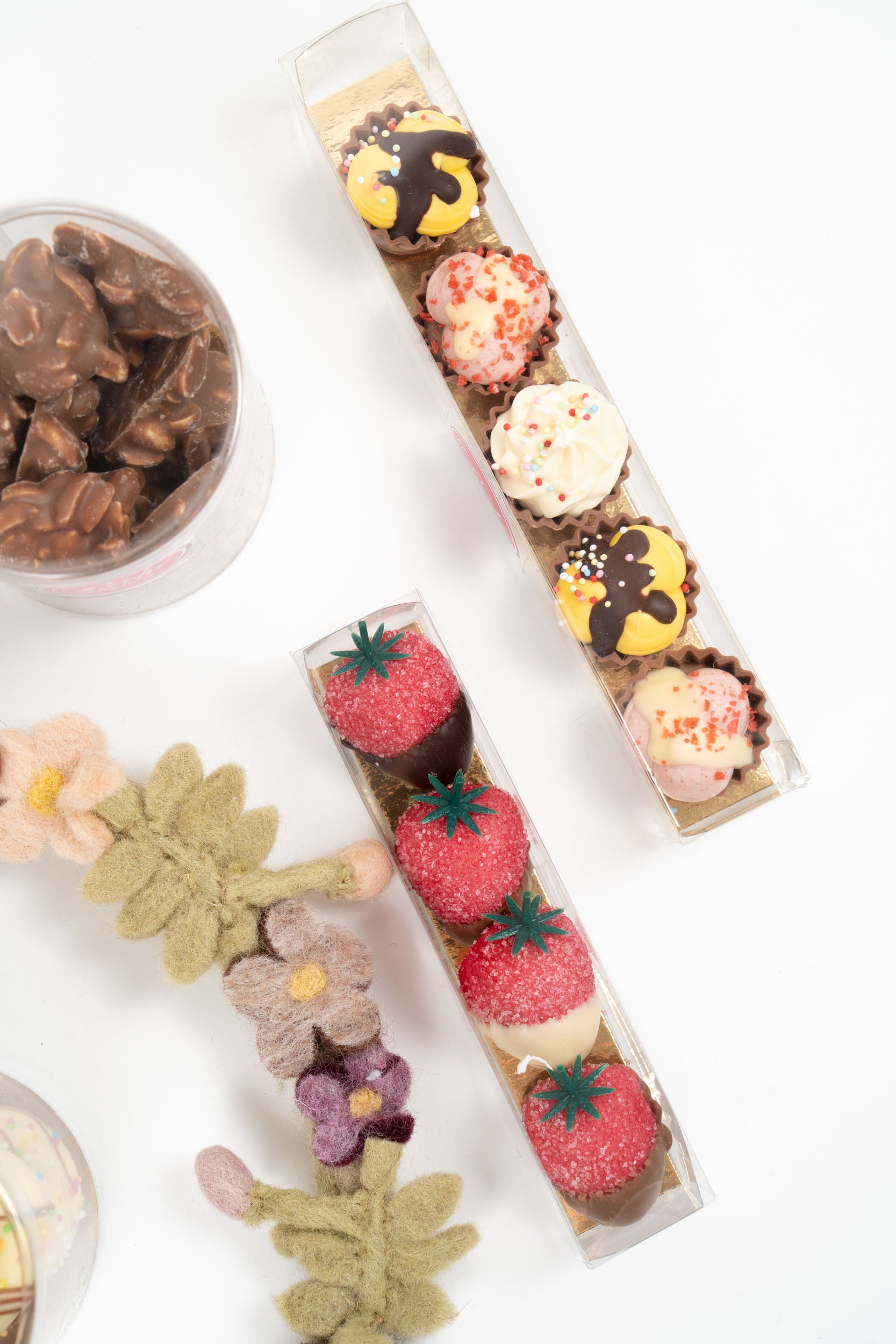 Assorted filled chocolate cupcakes and marzipan strawberries in a gourmet gift set