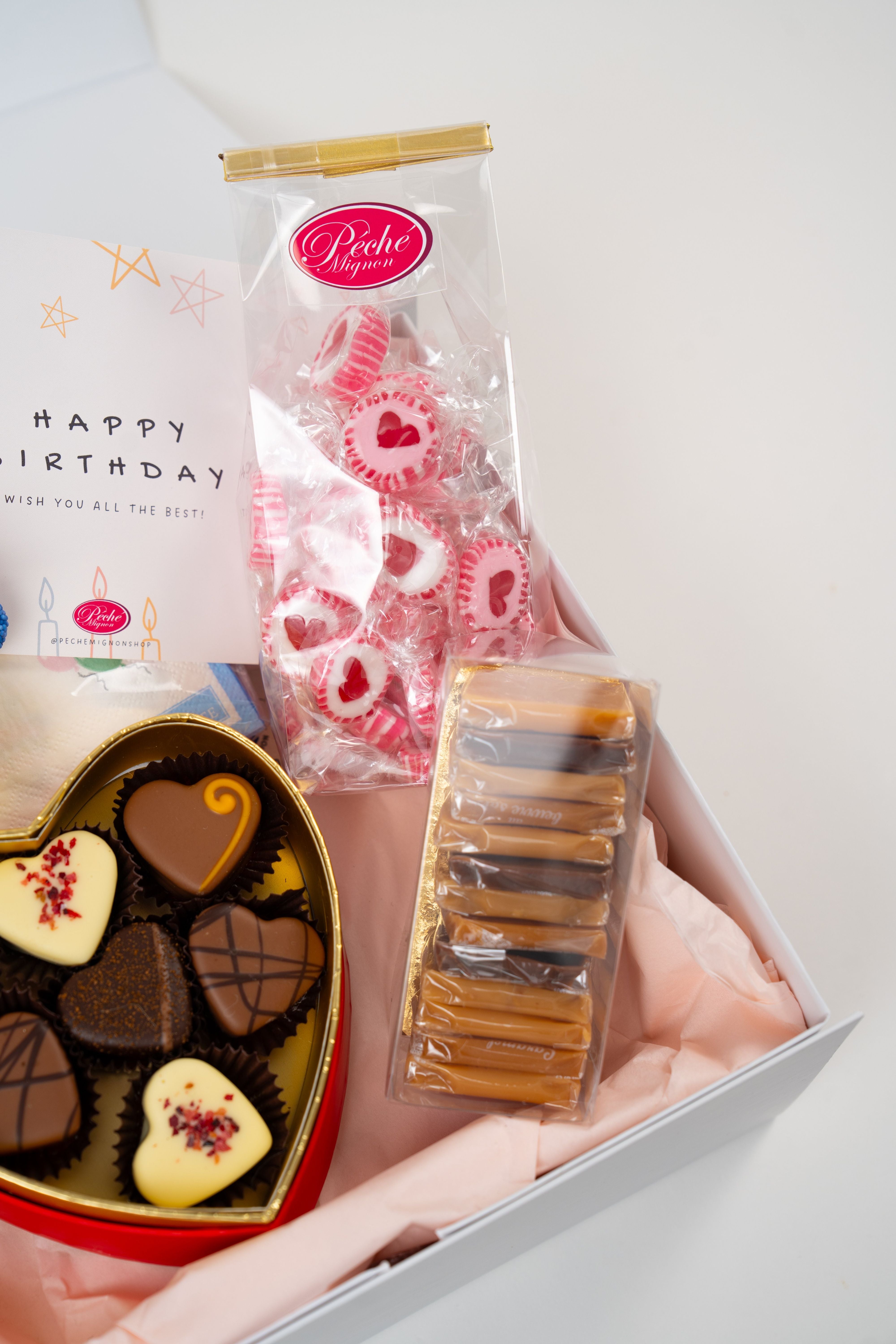 Close-up of heart shaped chocolate pralines in a luxury gift box from Péché Mignon.