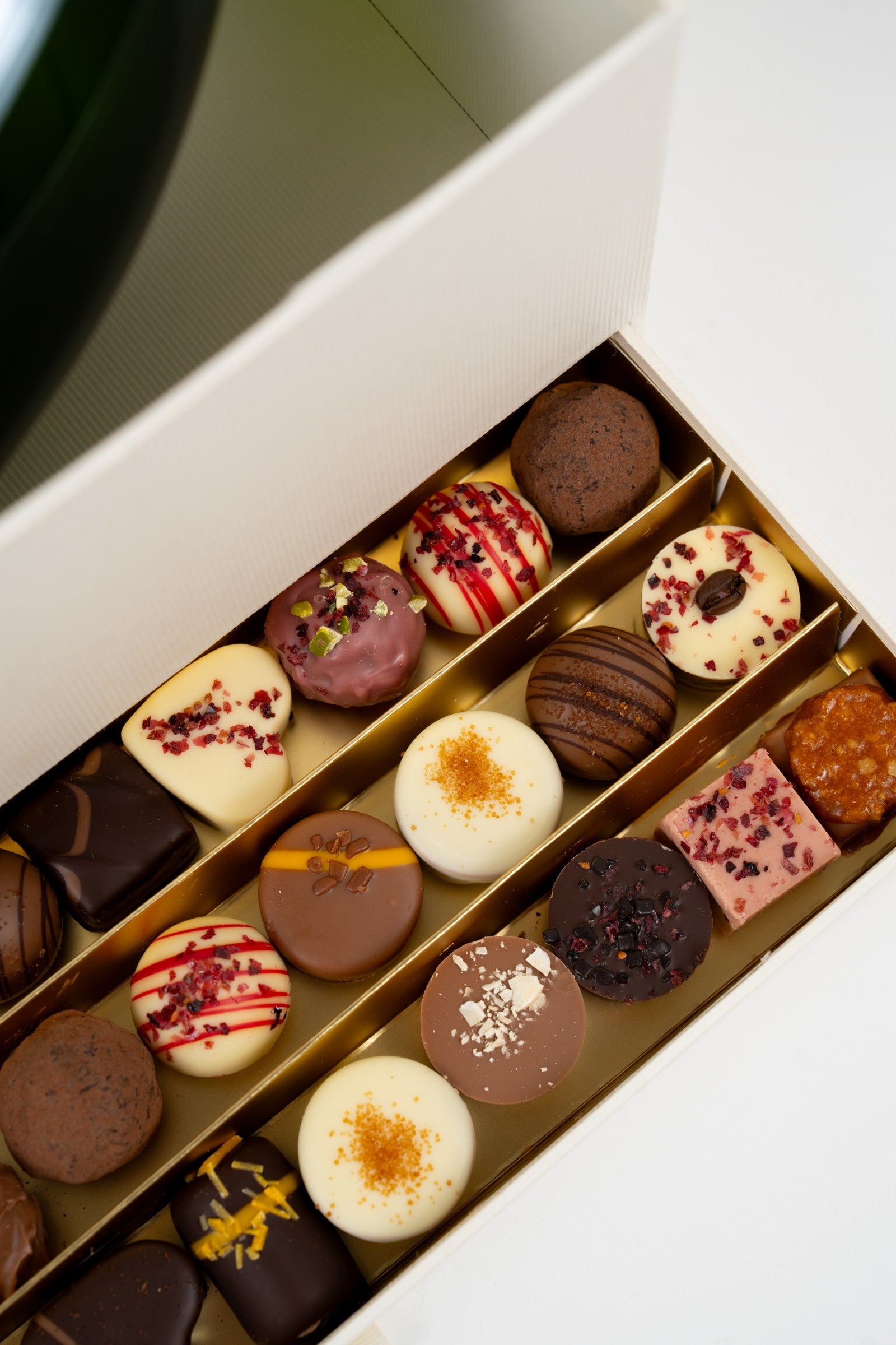 Closed Péché Mignon gift box with ribbon, ready to give