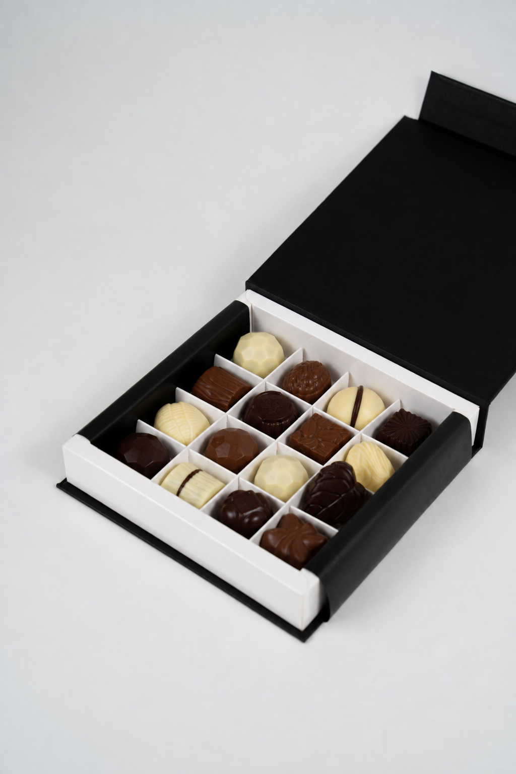 Coffret de pralines artisanales belges 200 g ouvert, présentant 16 pralines assorties