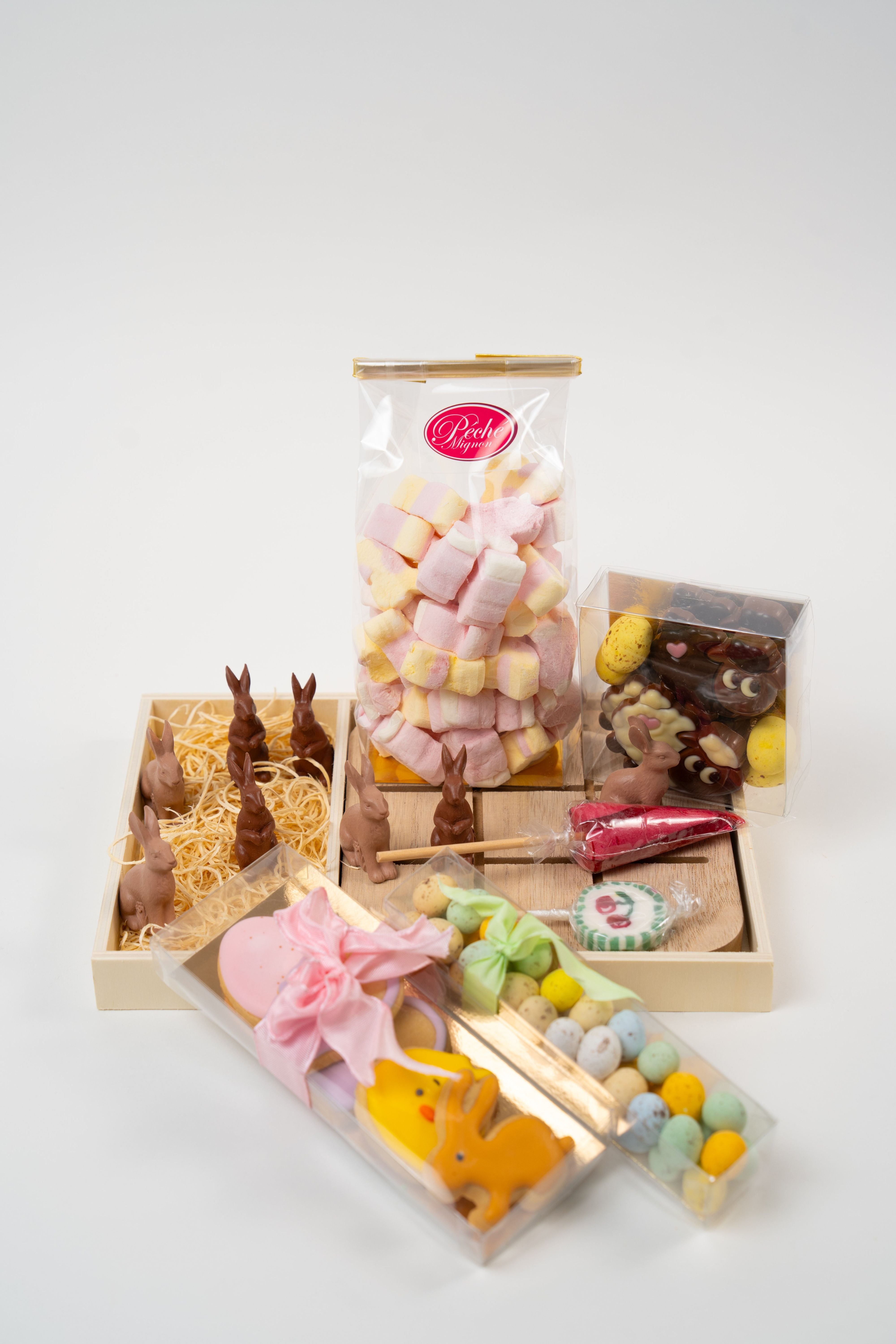 Easter sweet assortment with chocolate bunny tic tac toe game marshmallows cookies and candy eggs