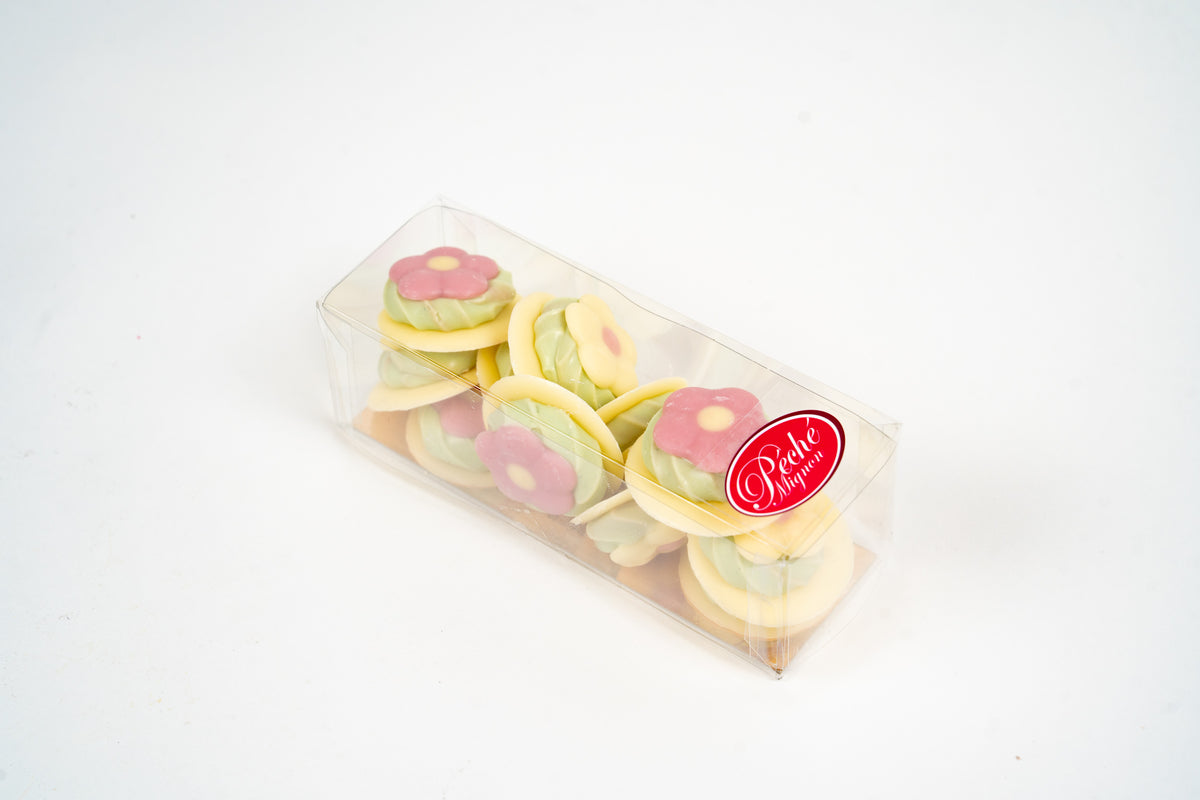 Pastel flower chocolate pralines in a transparent gift box by Péché Mignon