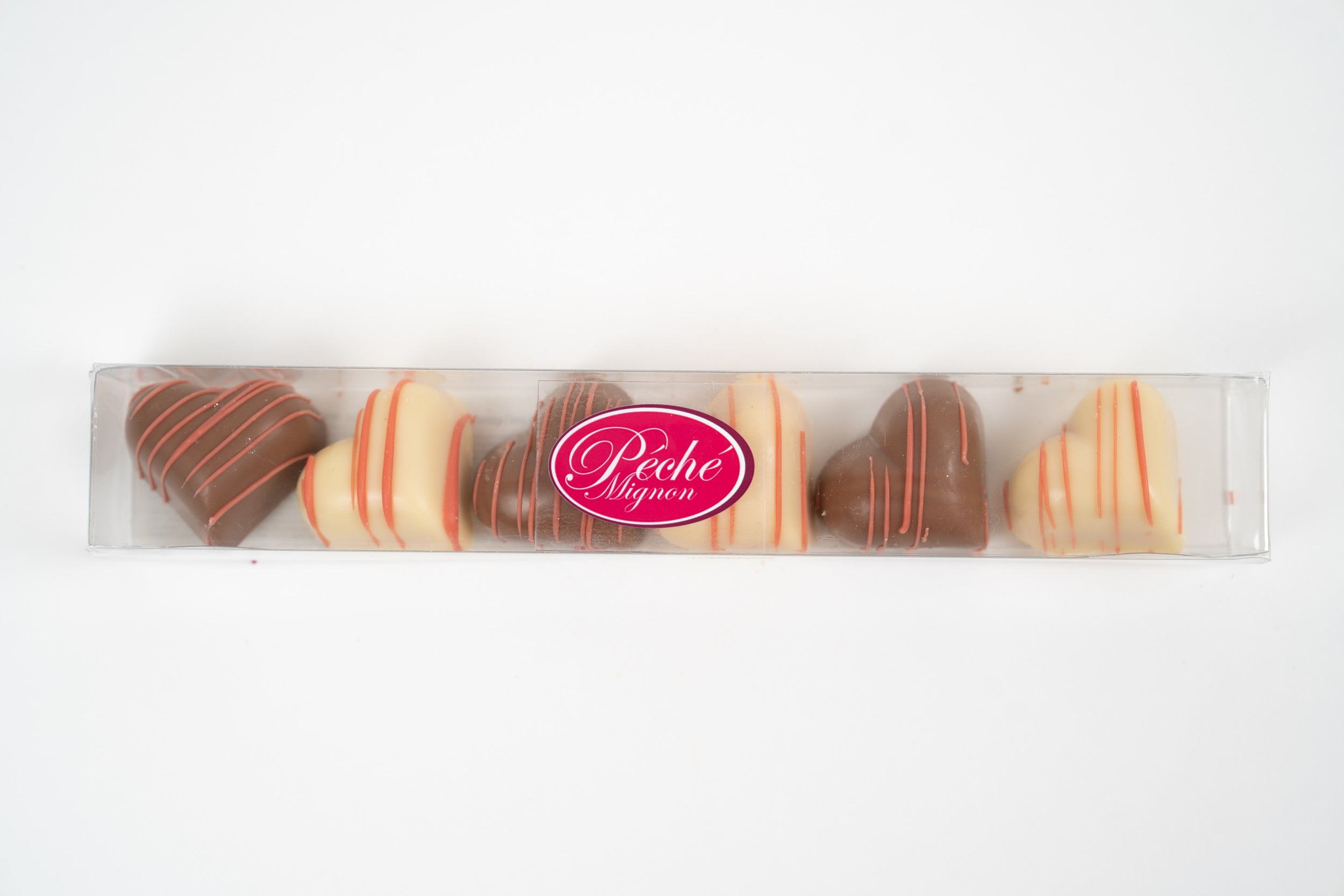 Heart shaped chocolates in gift box by Péché Mignon