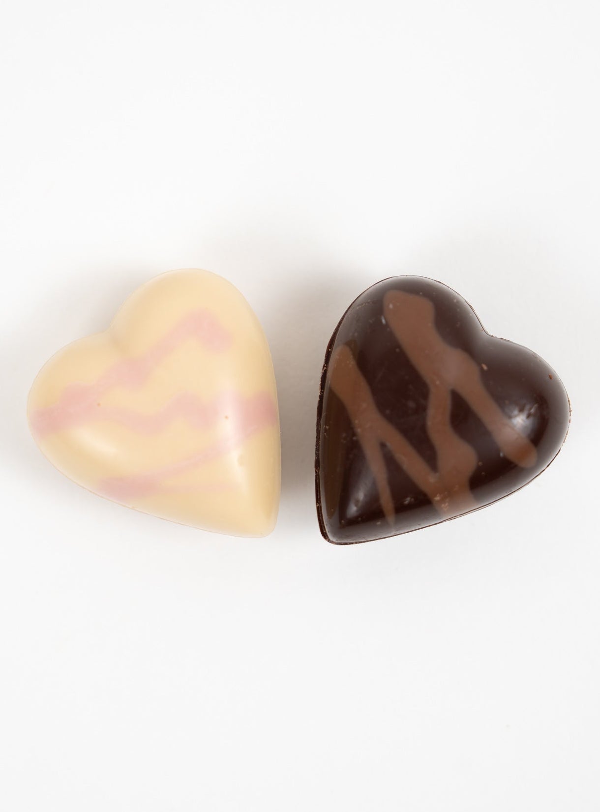 Assorted heart-shaped chocolates in milk and white chocolate