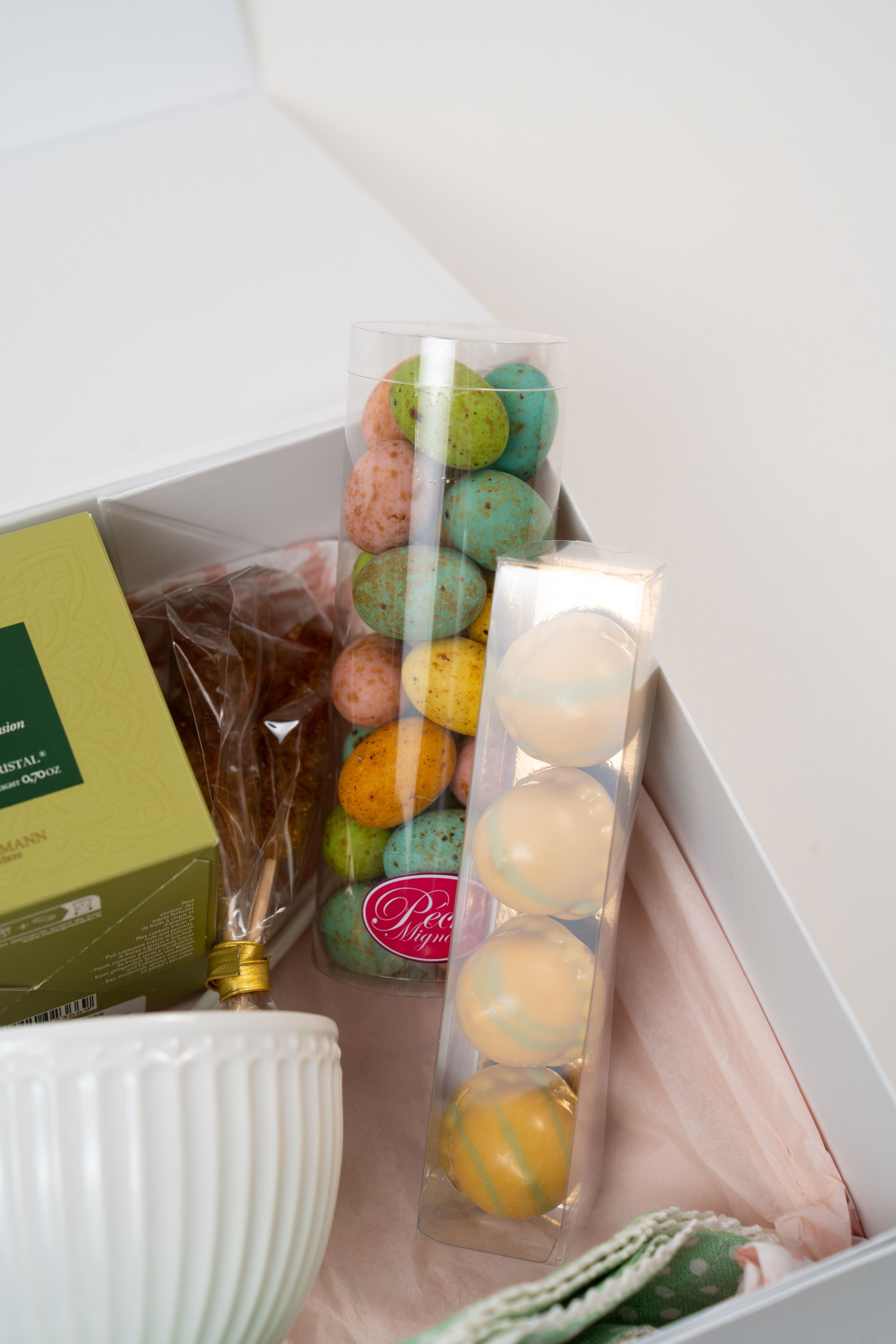 Close-up of Péché Mignon spring gift box with biscuits, chocolates and teacup