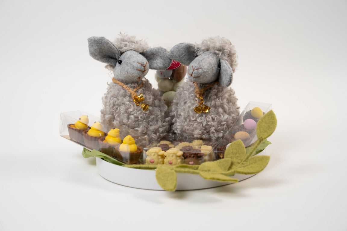 Easter chocolate gift platter with two grey plush lamb decorations and assorted artisanal chocolates from Le Péché Mignon.