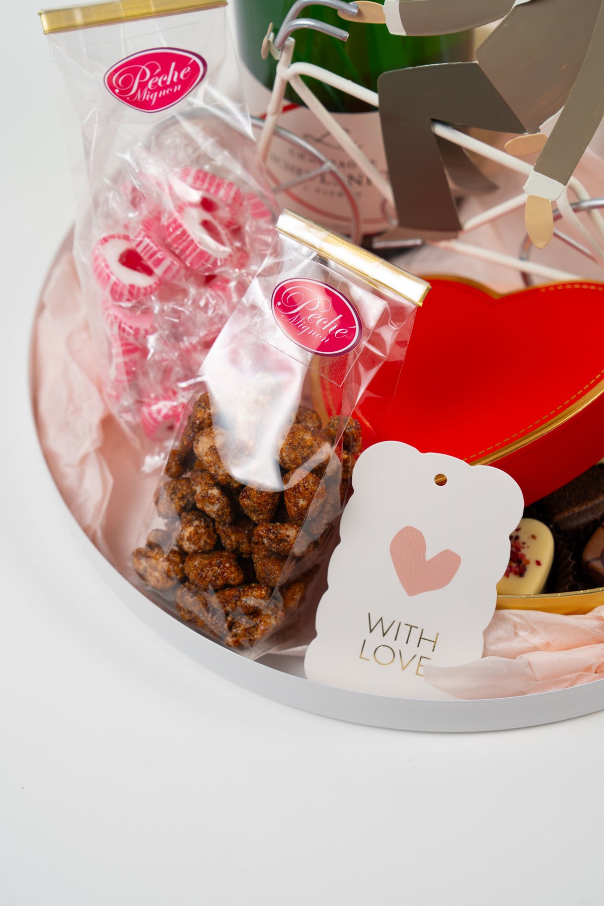 Close-up of gourmet sweets and candies in a romantic gift box from Péché Mignon.