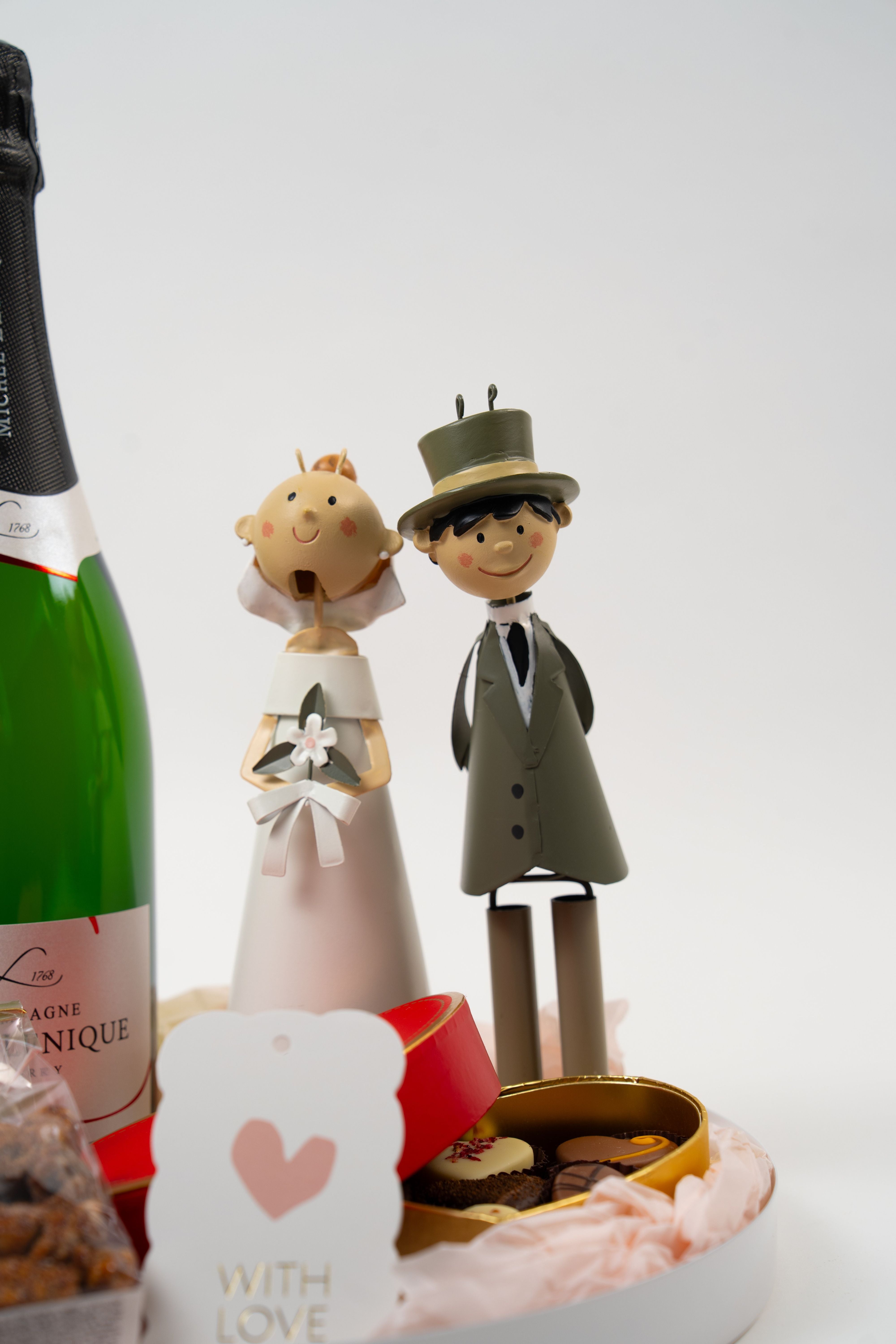 Bride and groom wedding figurines in a champagne and chocolate gift box from Péché Mignon.