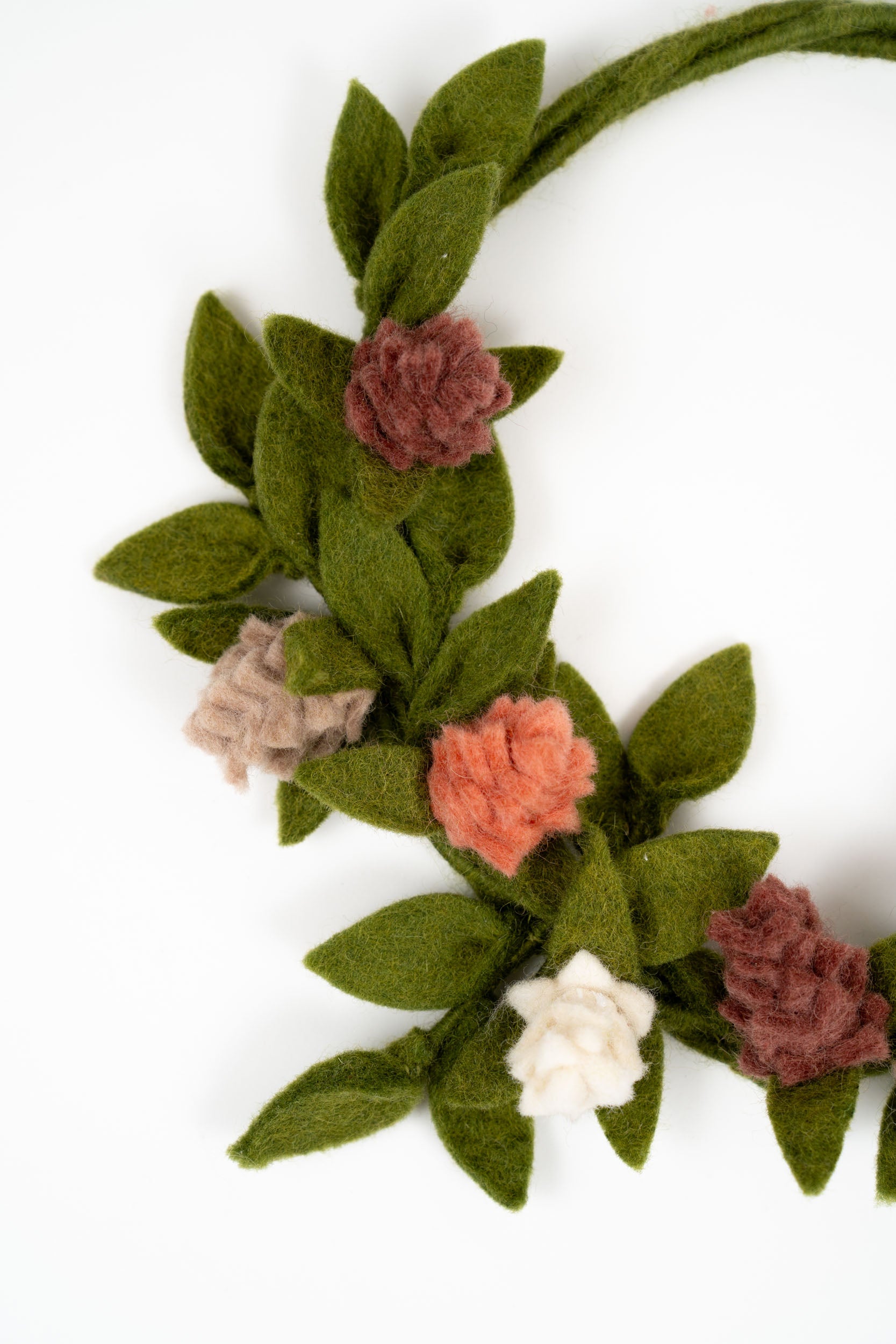 Gry & Sif felt rose door hanger styled on a cream interior door in soft natural light.