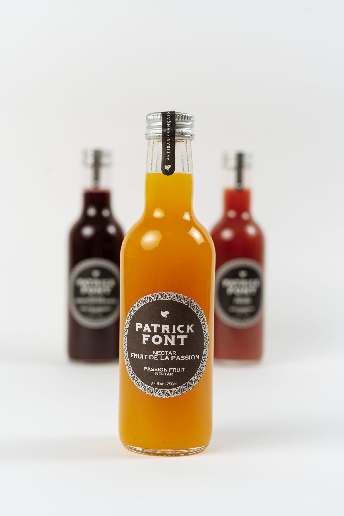 bottle of Patrick Font passion fruit nectar on white background