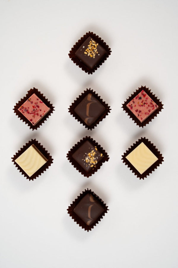 Assortiment de pralinés nougat vegan aux noisettes et framboises, cadeau gourmand.
