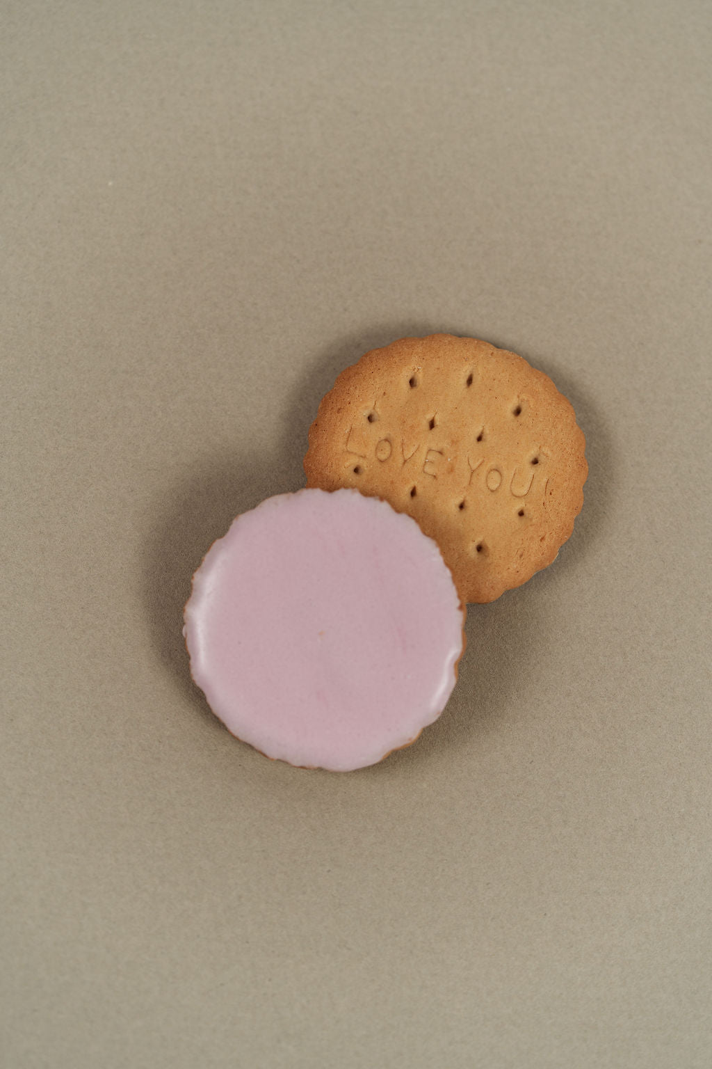 Pink iced sablé biscuit in detail