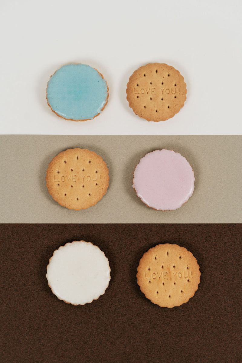 Assortment of pink, white and blue iced biscuits