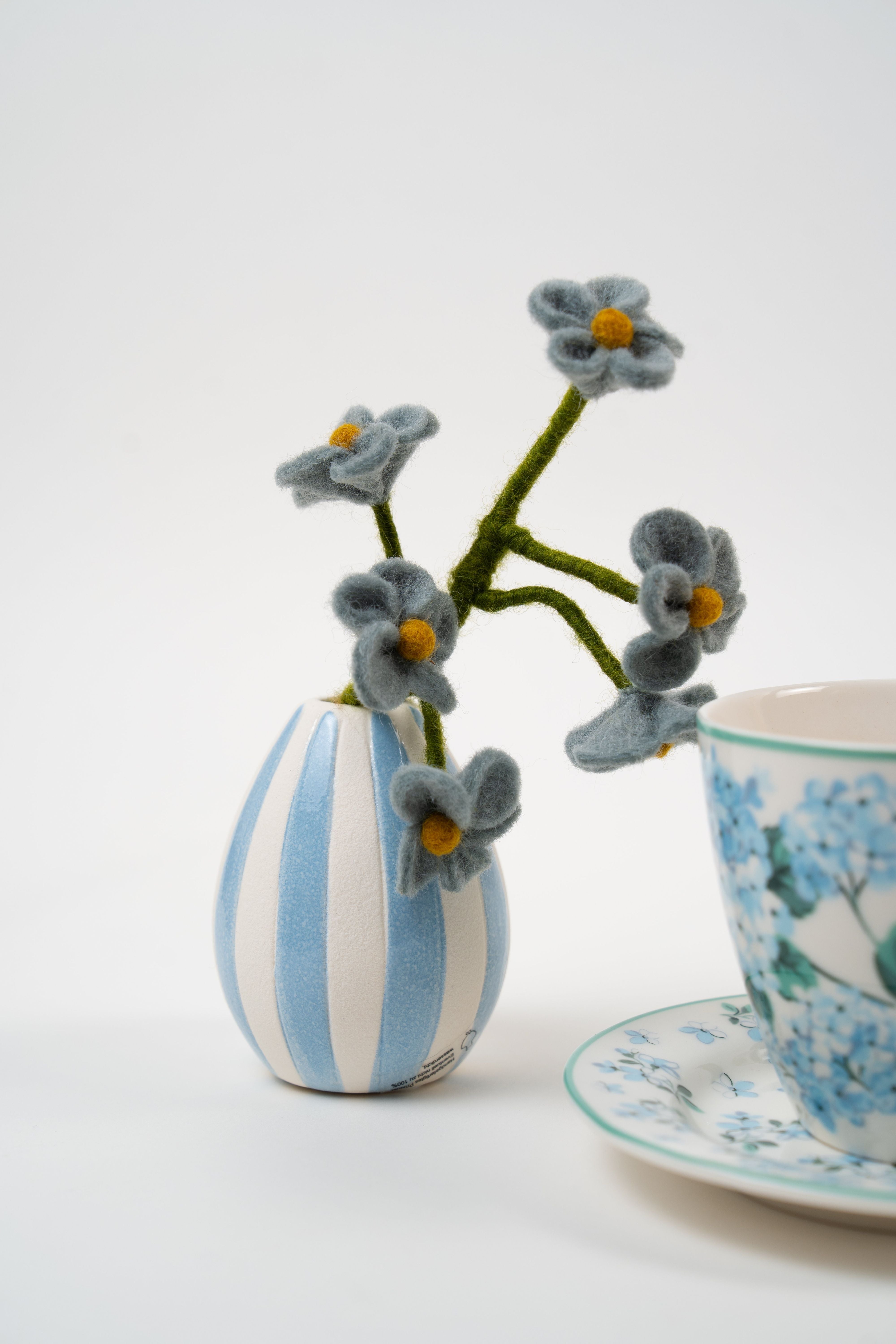 Decorative blue flower vase styled with Le Péché Mignon tea gift box