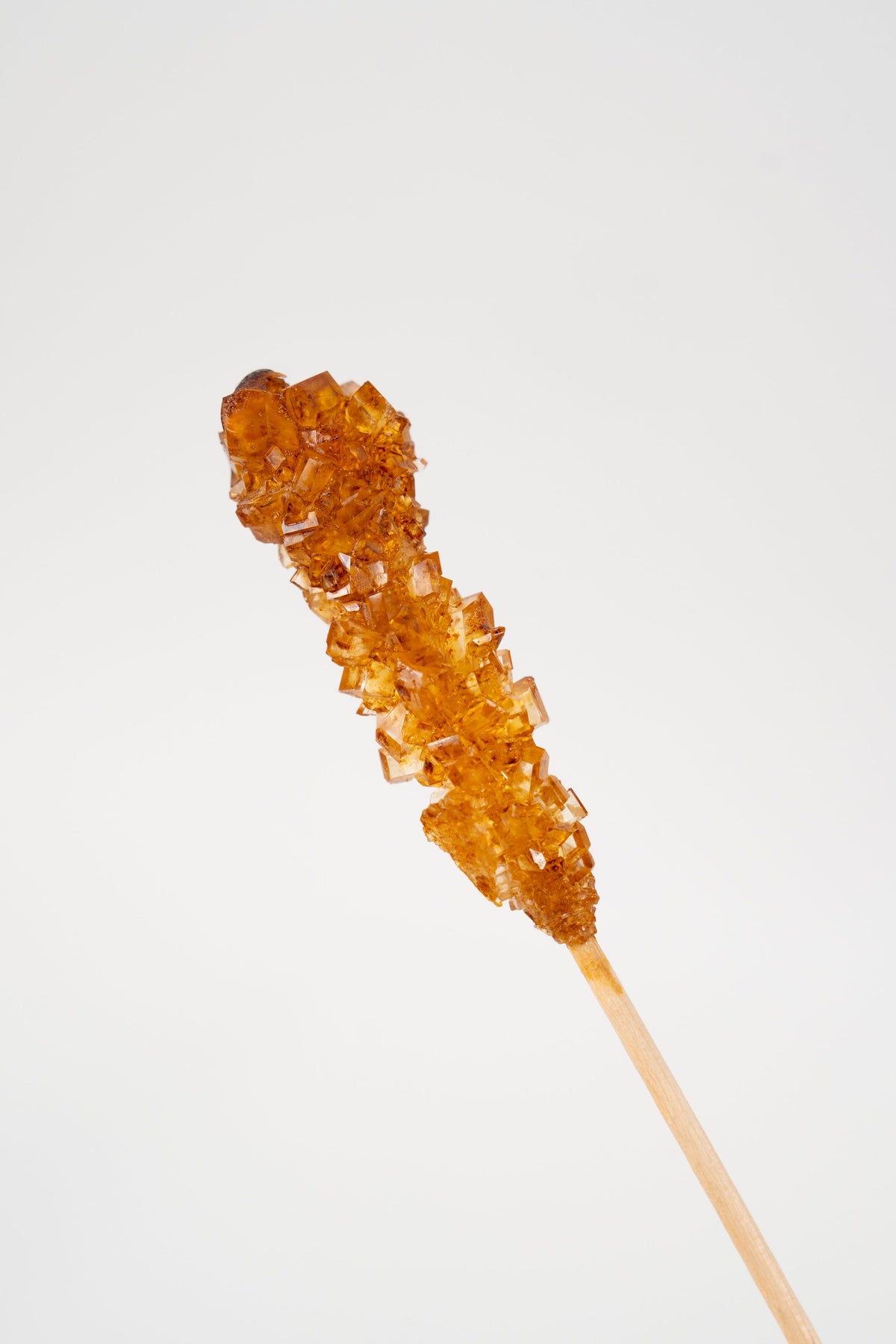 Brown rock sugar stick brauner kandis crystallized sugar on wooden stick