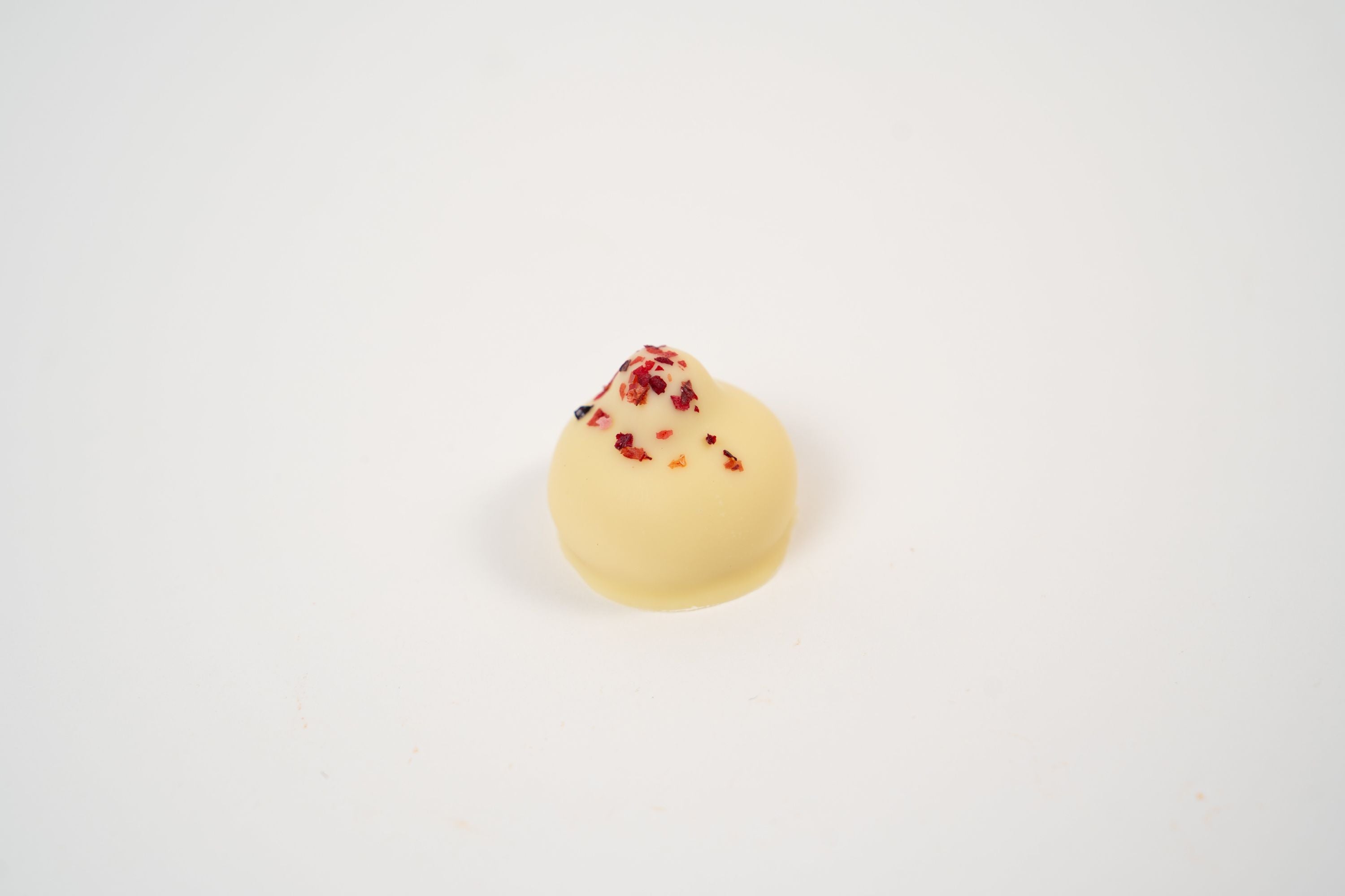 Ruby chocolate praline with caramelised hazelnuts and soft butter mousse centre.