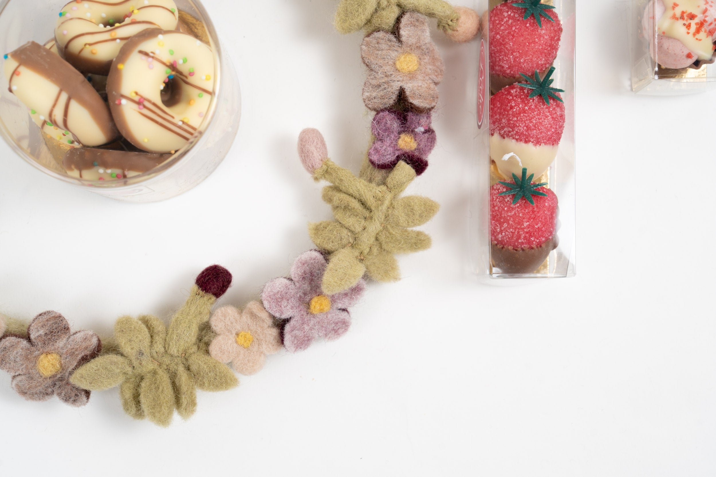 Close-up of chocolate donuts and Gry & Sif felt flower wreath in a premium gift box