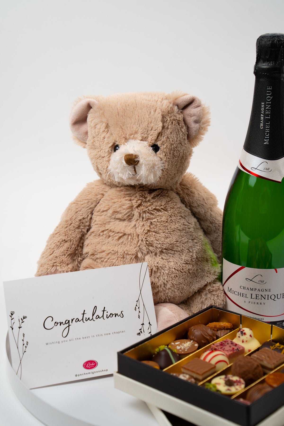 Bienvenue bébé gift set with teddy bear, champagne and artisan chocolates from Péché Mignon