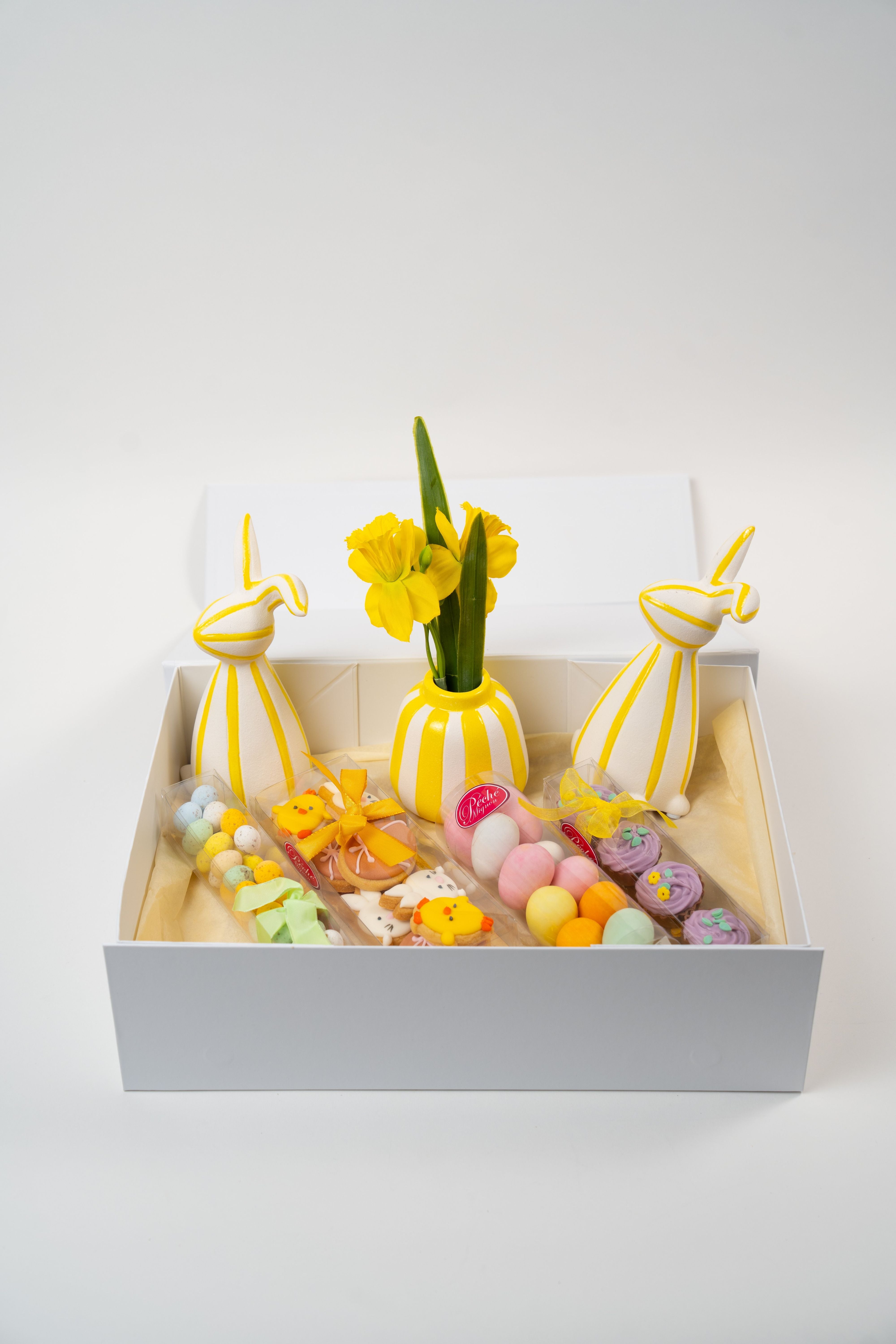 Easter gift box with chocolates, pastel eggs, cookies and spring decorations from Péché Mignon.