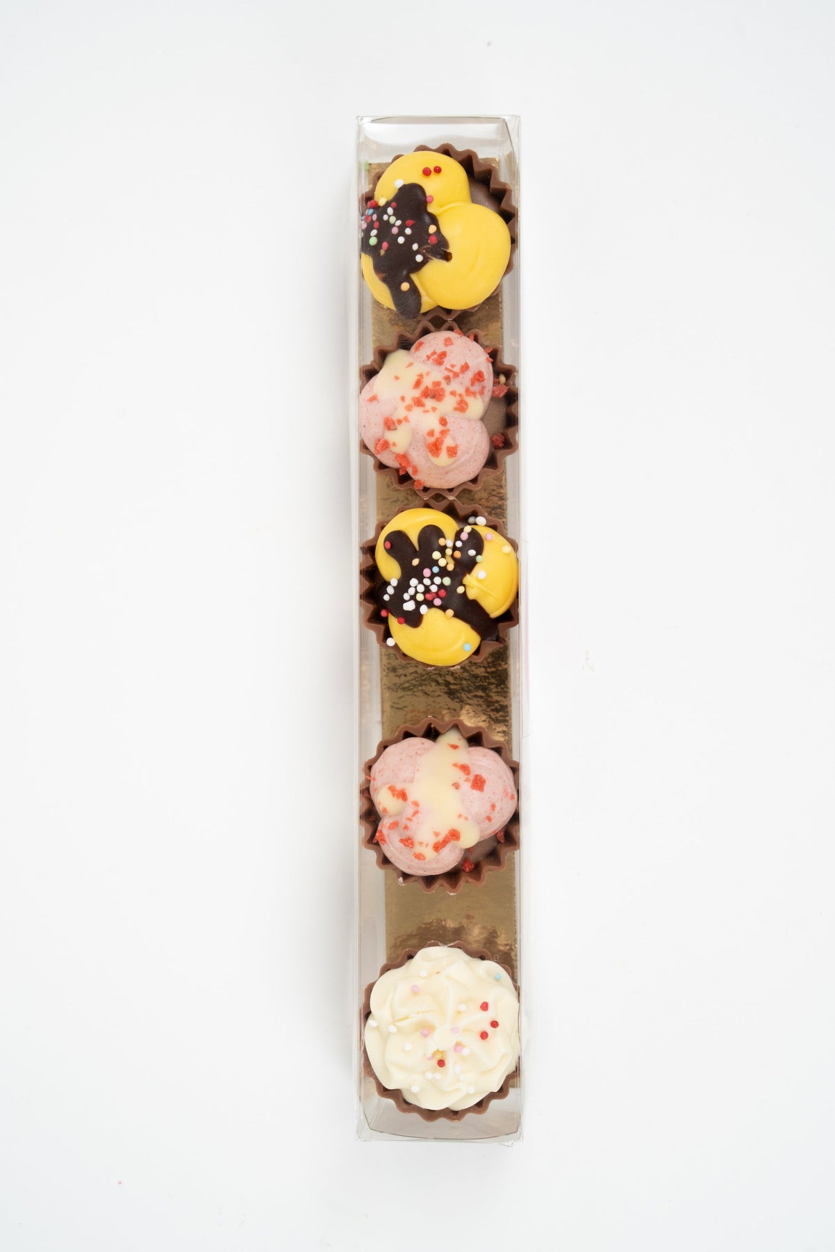 Top view of assorted filled chocolate cupcakes with colourful toppings and gourmet flavours