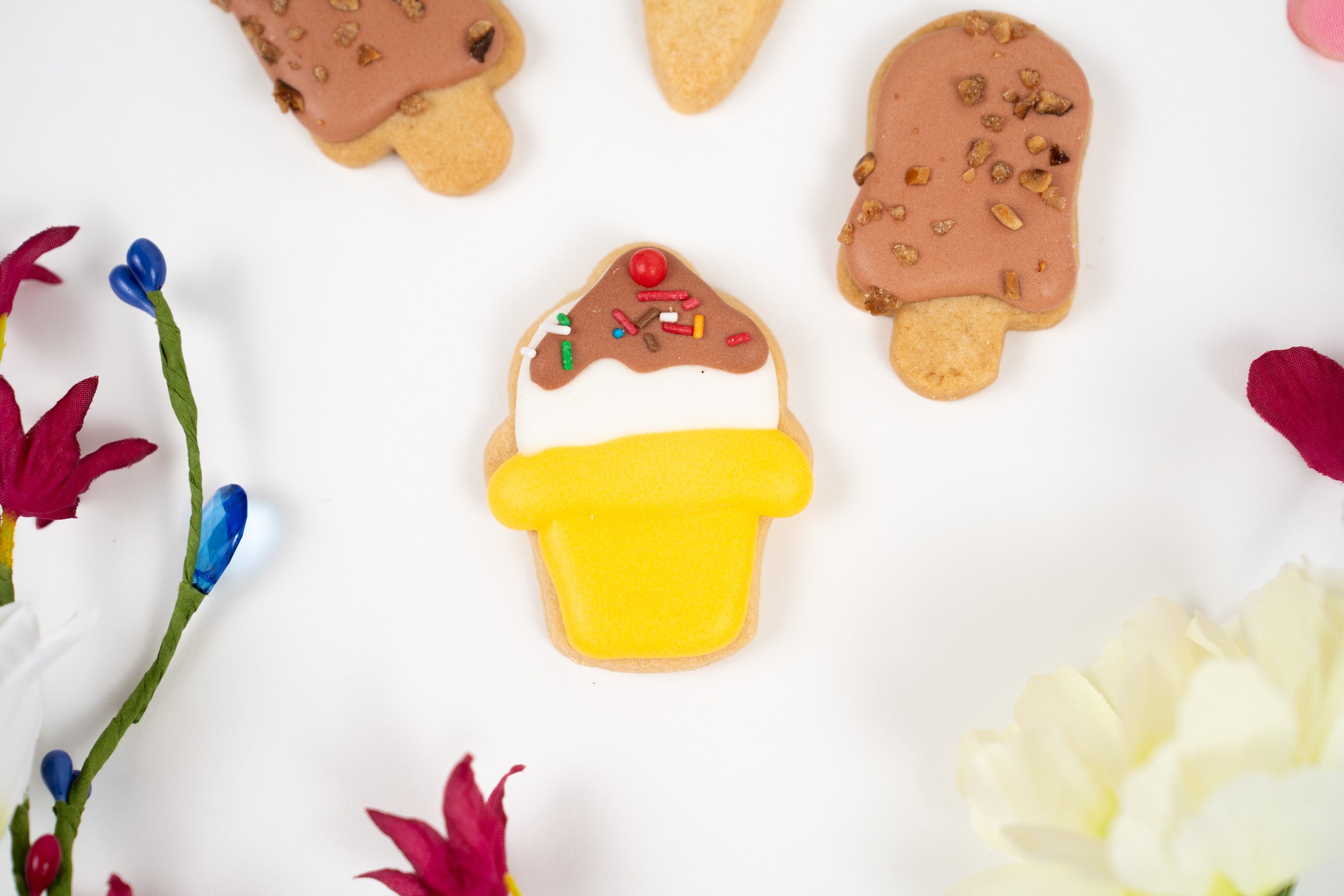 Close-up of iced artisan biscuits with chocolate topping and decorative sprinkles