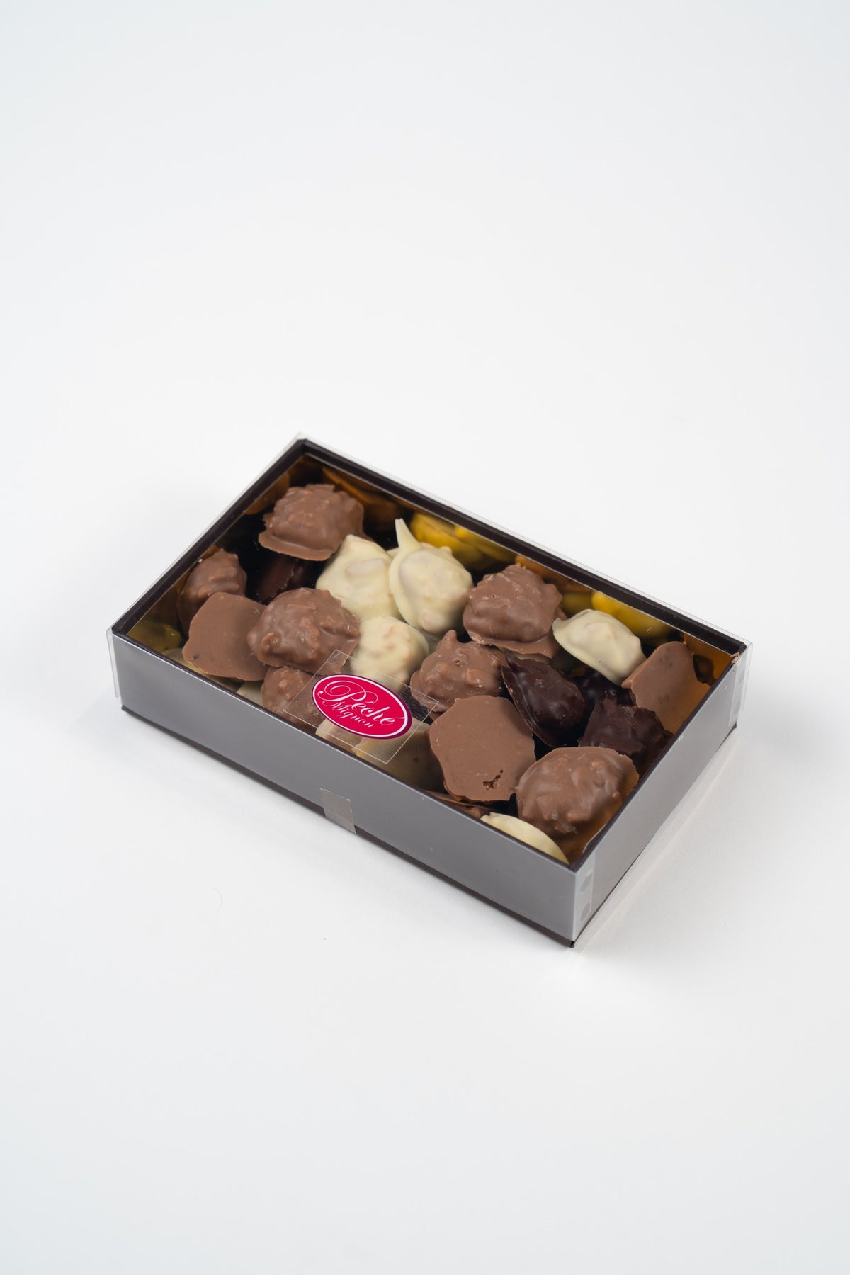 Boîte de 250 g contenant un assortiment de mini Weichprinten aux noisettes enrobés de chocolat blanc, au lait et noir.