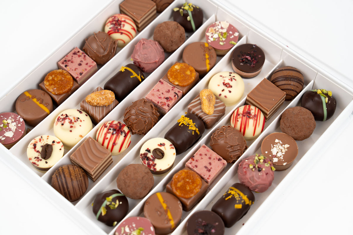 Close-up of assorted German pralines in Nessi coffret 525g featuring ganache, truffles and layered chocolates