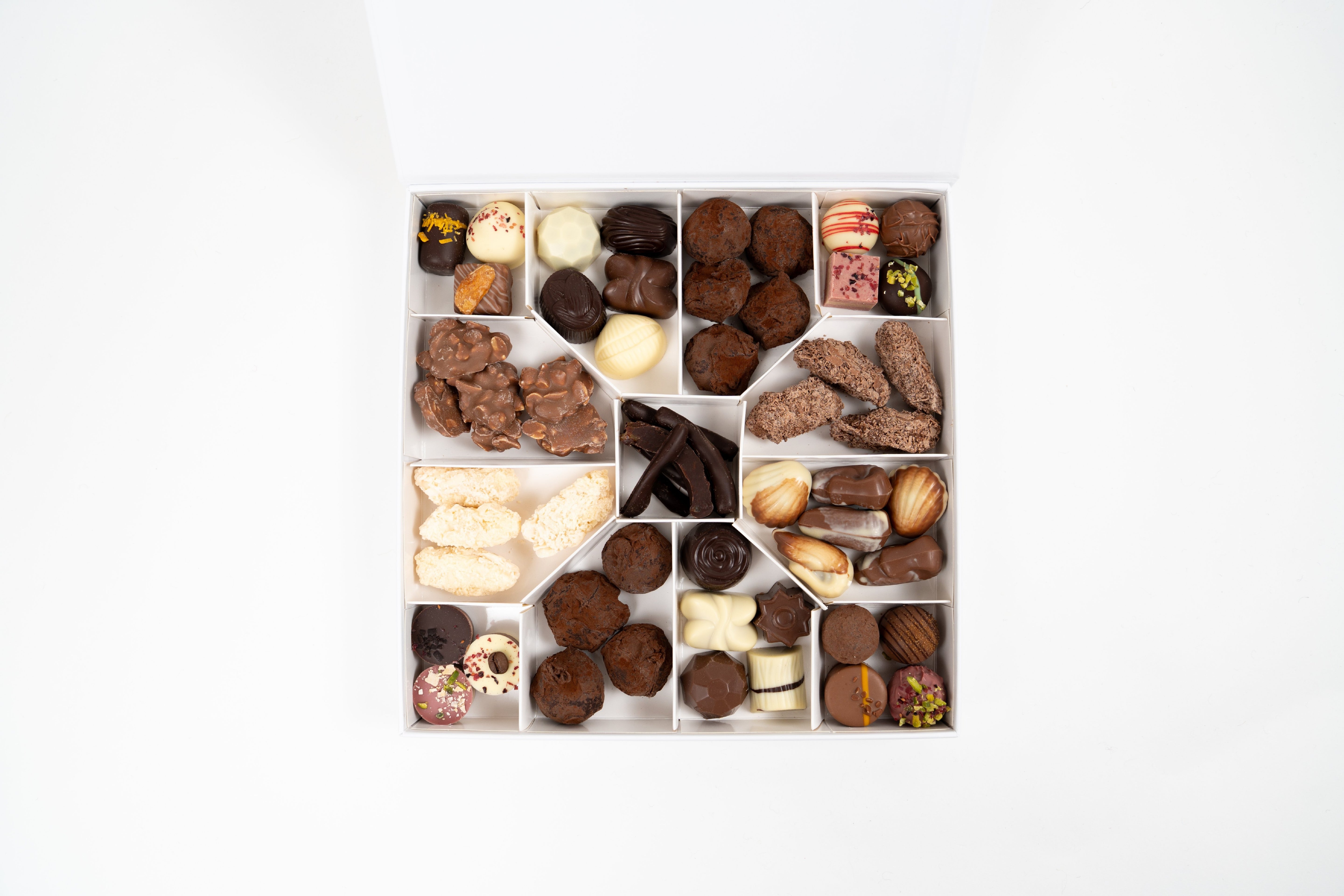 Coffret gourmand Péché Mignon avec assortiment de chocolats artisanaux, biscuits raffinés et douceurs sucrées présentés dans une boîte élégante.