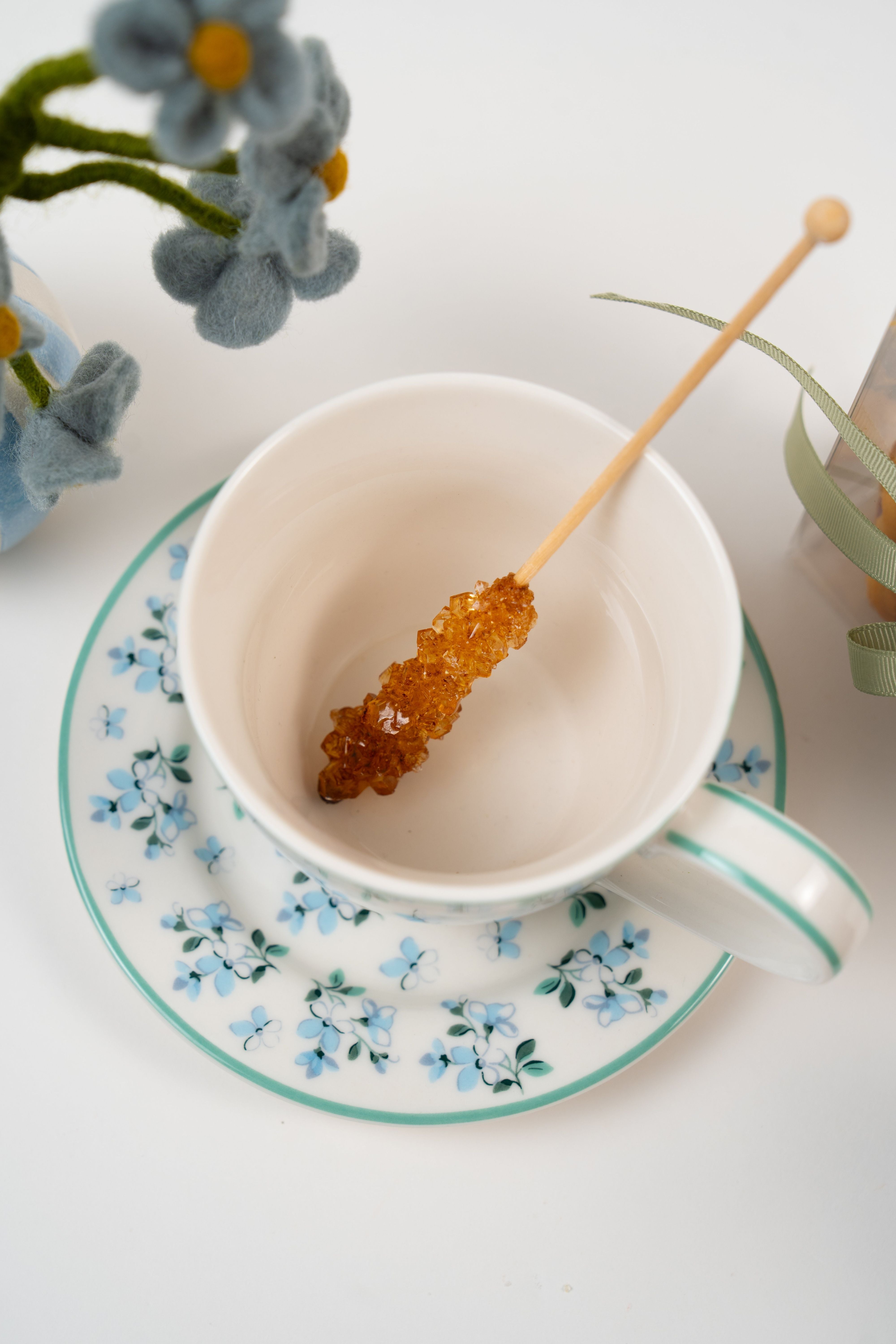 Rock sugar stick placed in porcelain teacup styled for Le Péché Mignon Tea Bliss gift box
