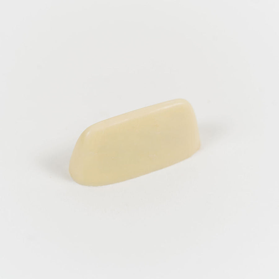 Artisan Belgian Beurre Salé Blanc praline in white chocolate with salted butter caramel, on a white background.