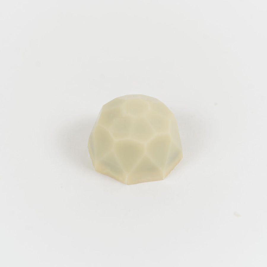 Artisan Belgian Diamant Blanc praline in white chocolate with coffee praline, on a white background.