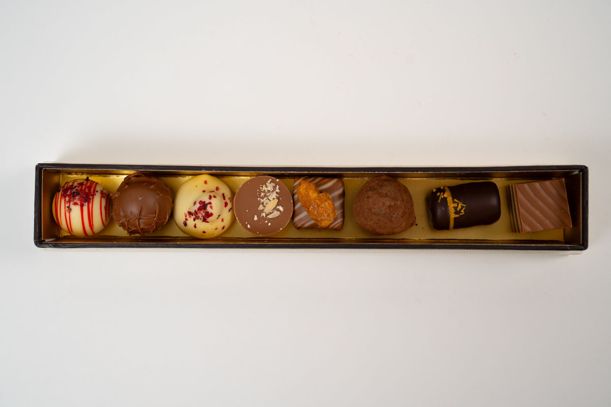 Assorted chocolate pralines selection box with eight handmade pralines including nougat, marzipan, vanilla cream and strawberry balsamic flavours.