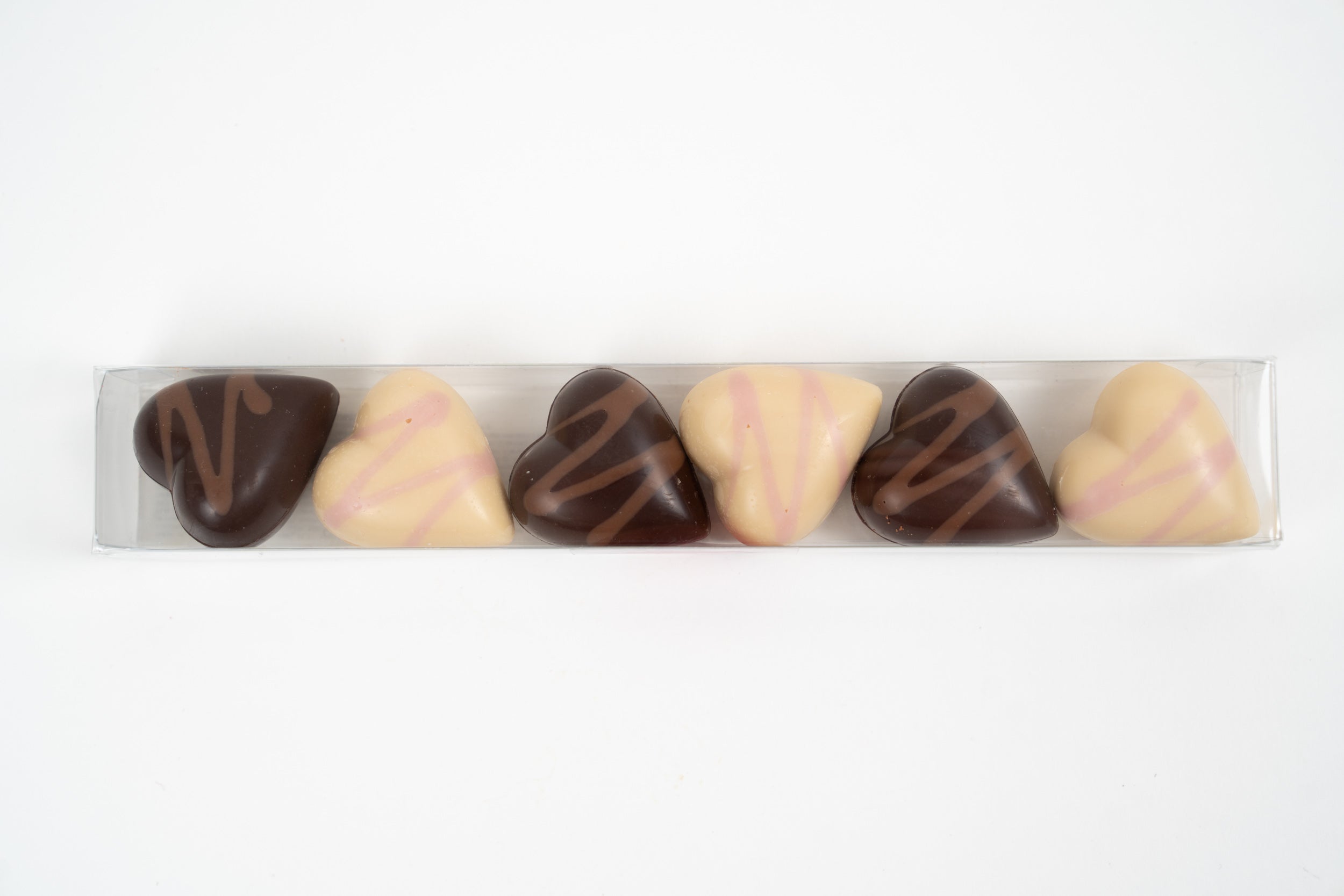 Assorted heart chocolates with strawberry and raspberry fillings in a gift box