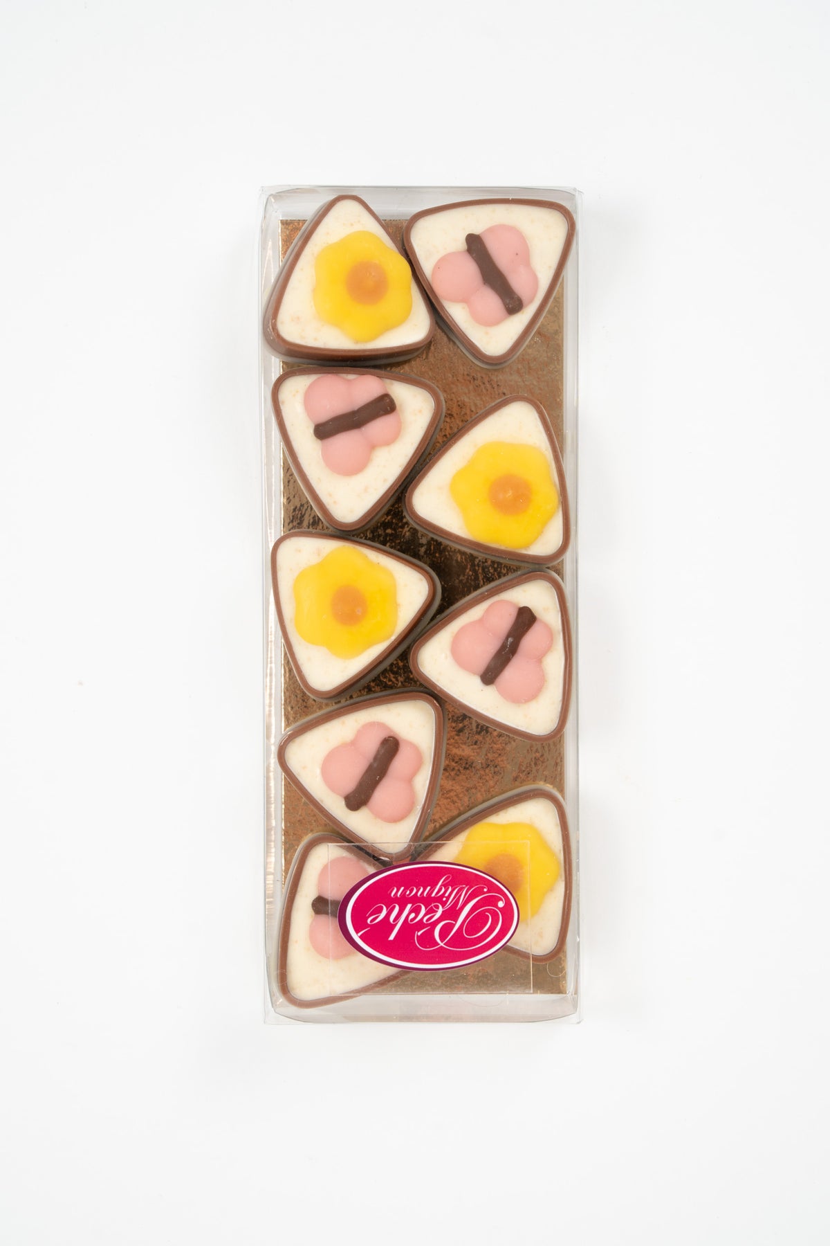 Assorted triangular chocolate pralines with flower decoration in a transparent gift box by Péché Mignon