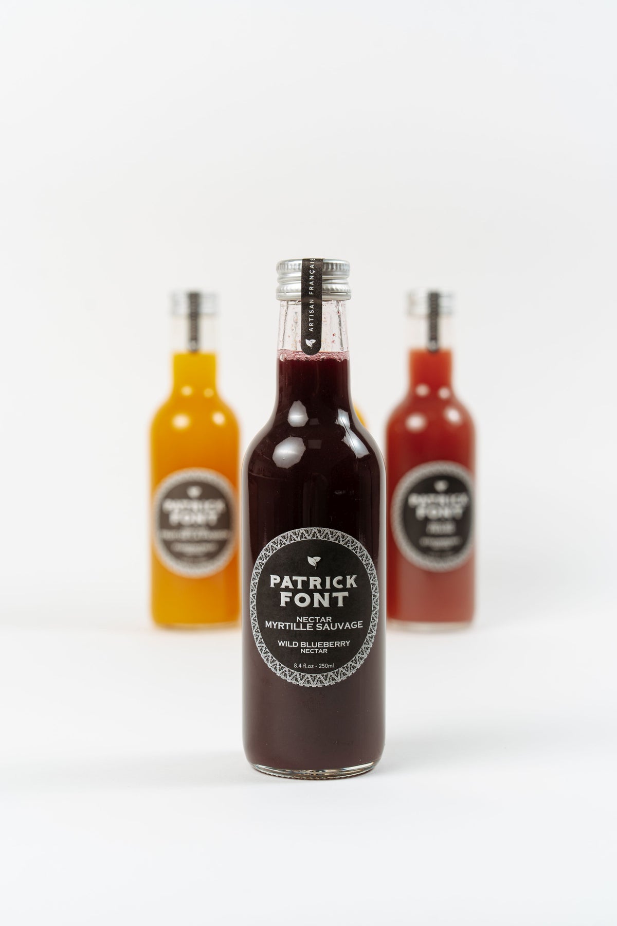 bottle of Patrick Font wild blueberry nectar on neutral background