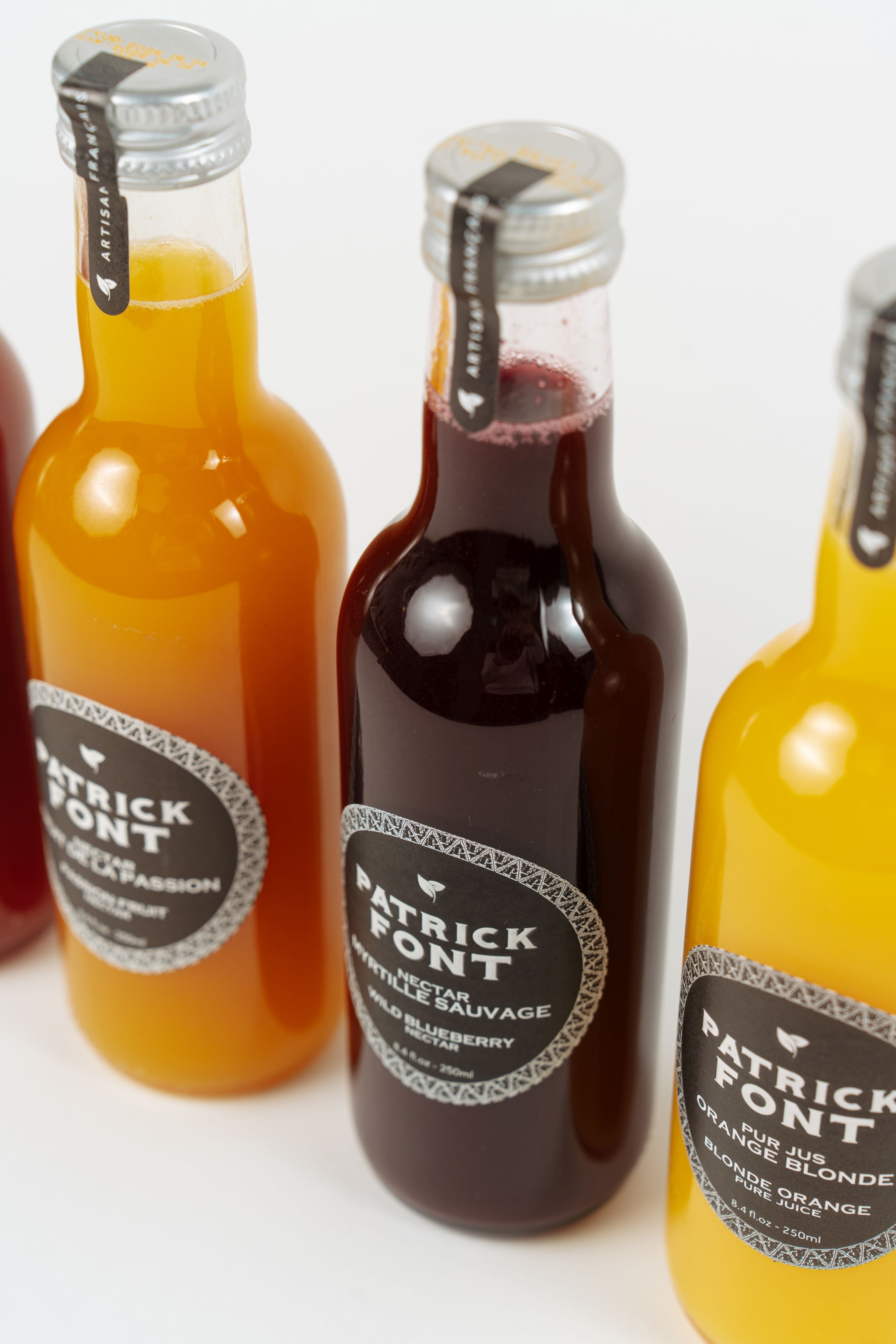 Bottle of Patrick Font wild blueberry nectar on neutral background